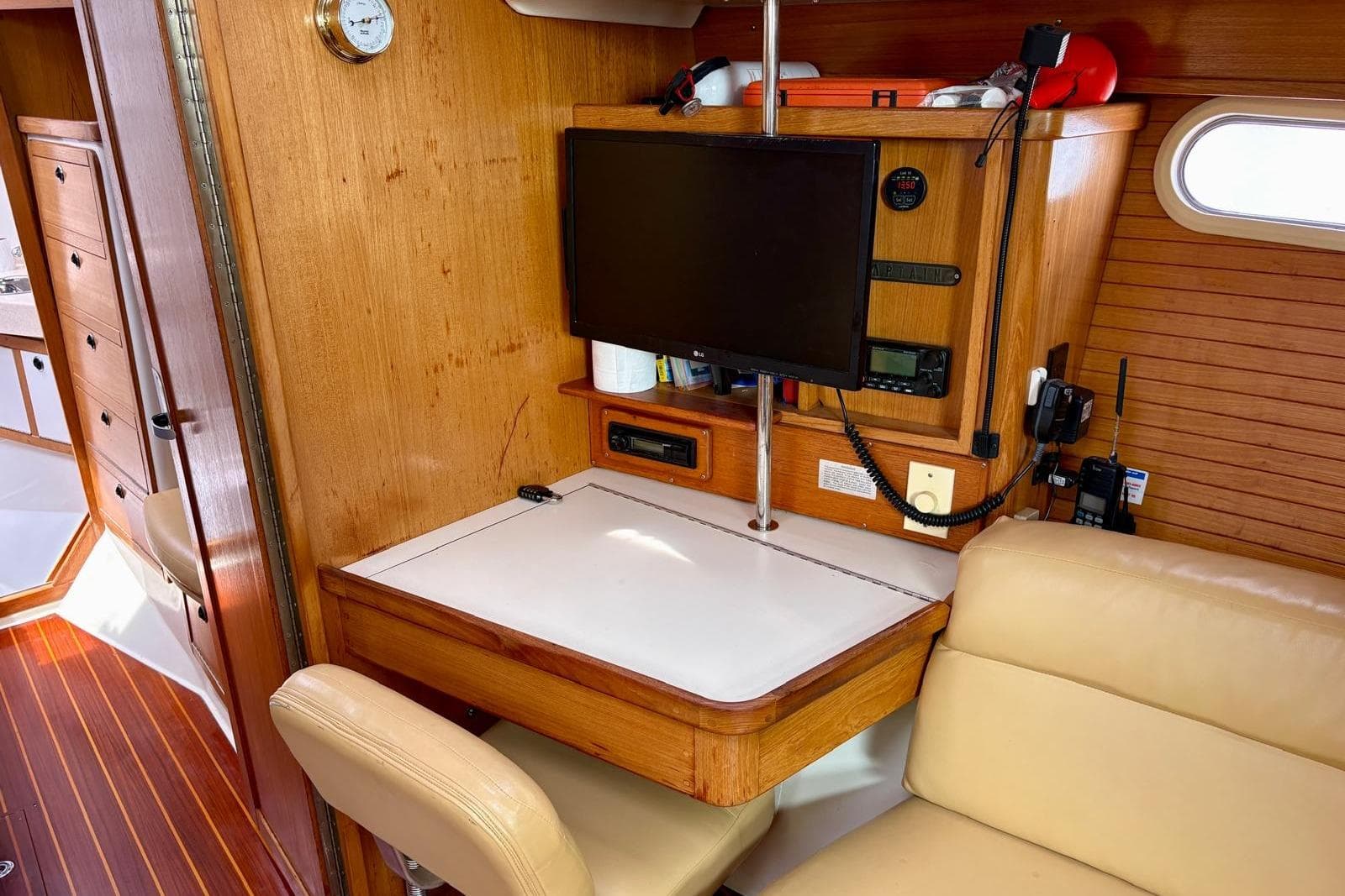 Navigation station inside 2000 Catalina 42 MkII sailboat with wood paneling and mounted electronics.