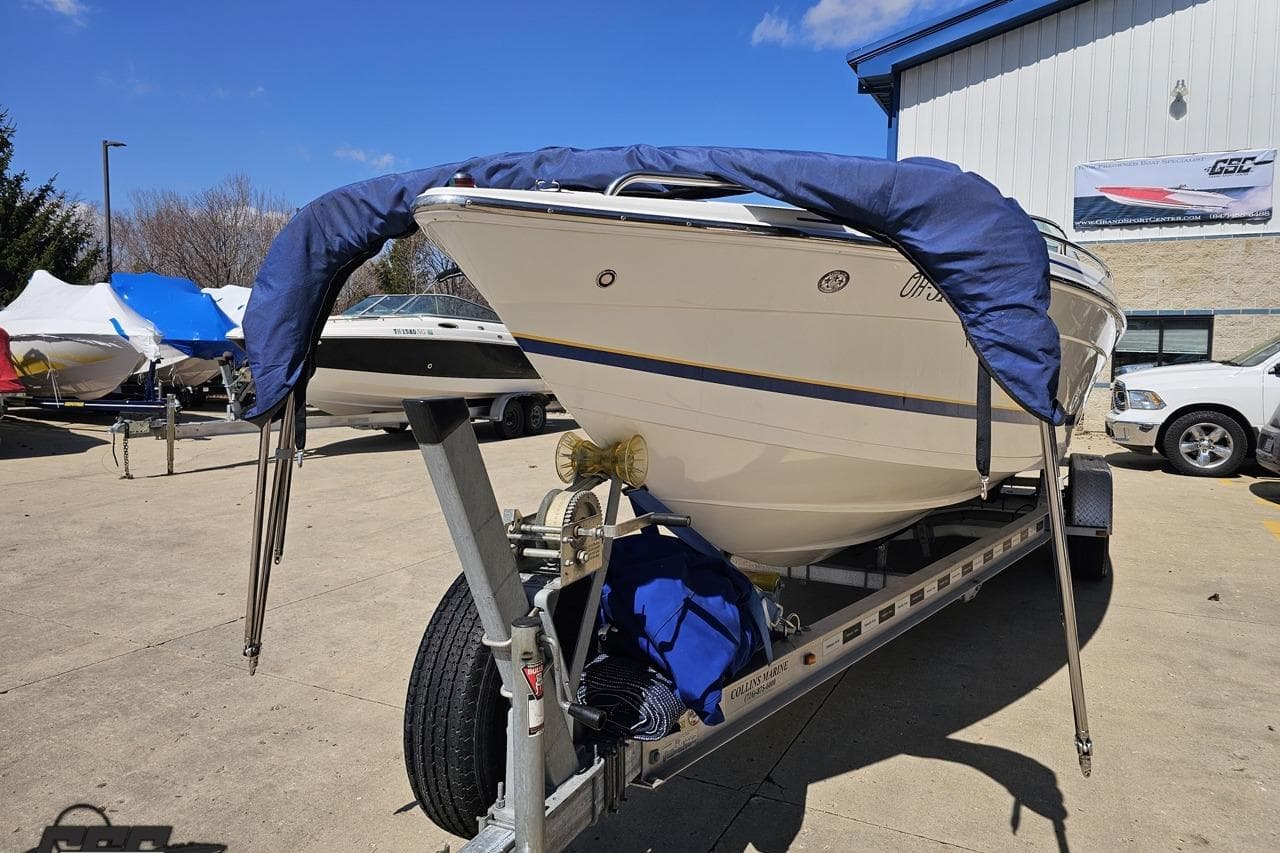 2008 Formula 271 FASTech boat on trailer, covered and parked outdoors.