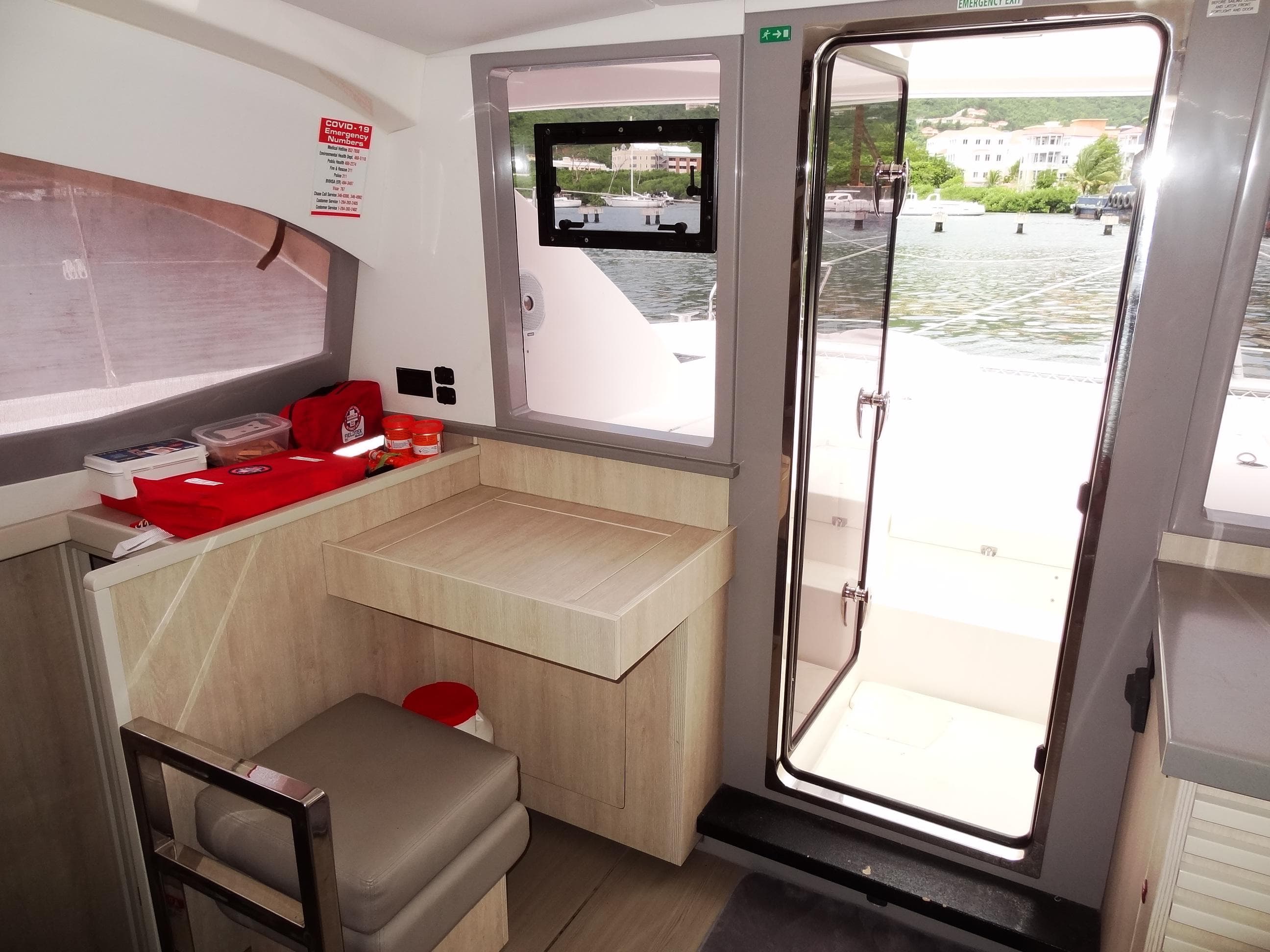 Interior of 2020 Leopard 40 catamaran with desk, chair, and door to deck.
