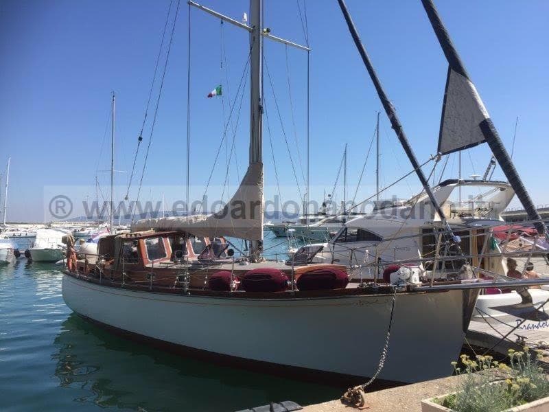 1956 Sangermani Motorsailer docked in a sunny marina, showcasing classic wooden design.