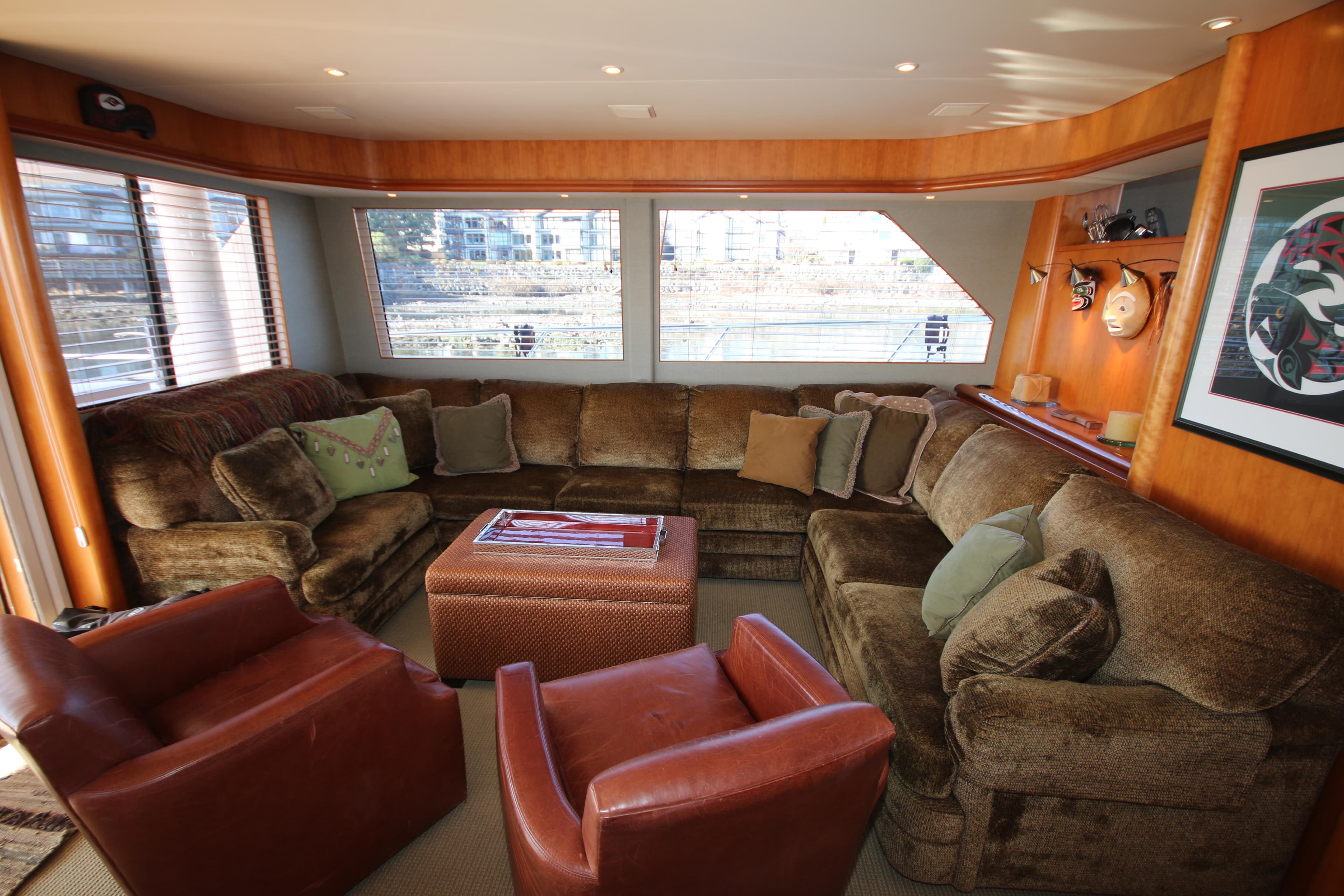 Luxurious interior of 2004 West Bay 68 Sonship Pilothouse with plush seating and large windows.