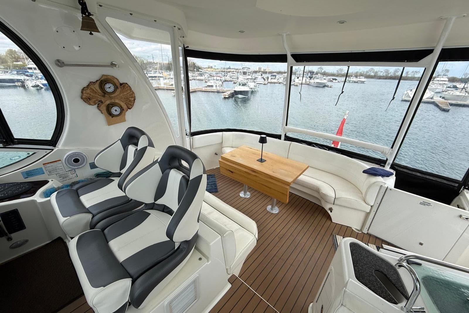 Luxurious 2005 Cruisers Yachts 455 Express Motoryacht interior with seating and marina view.