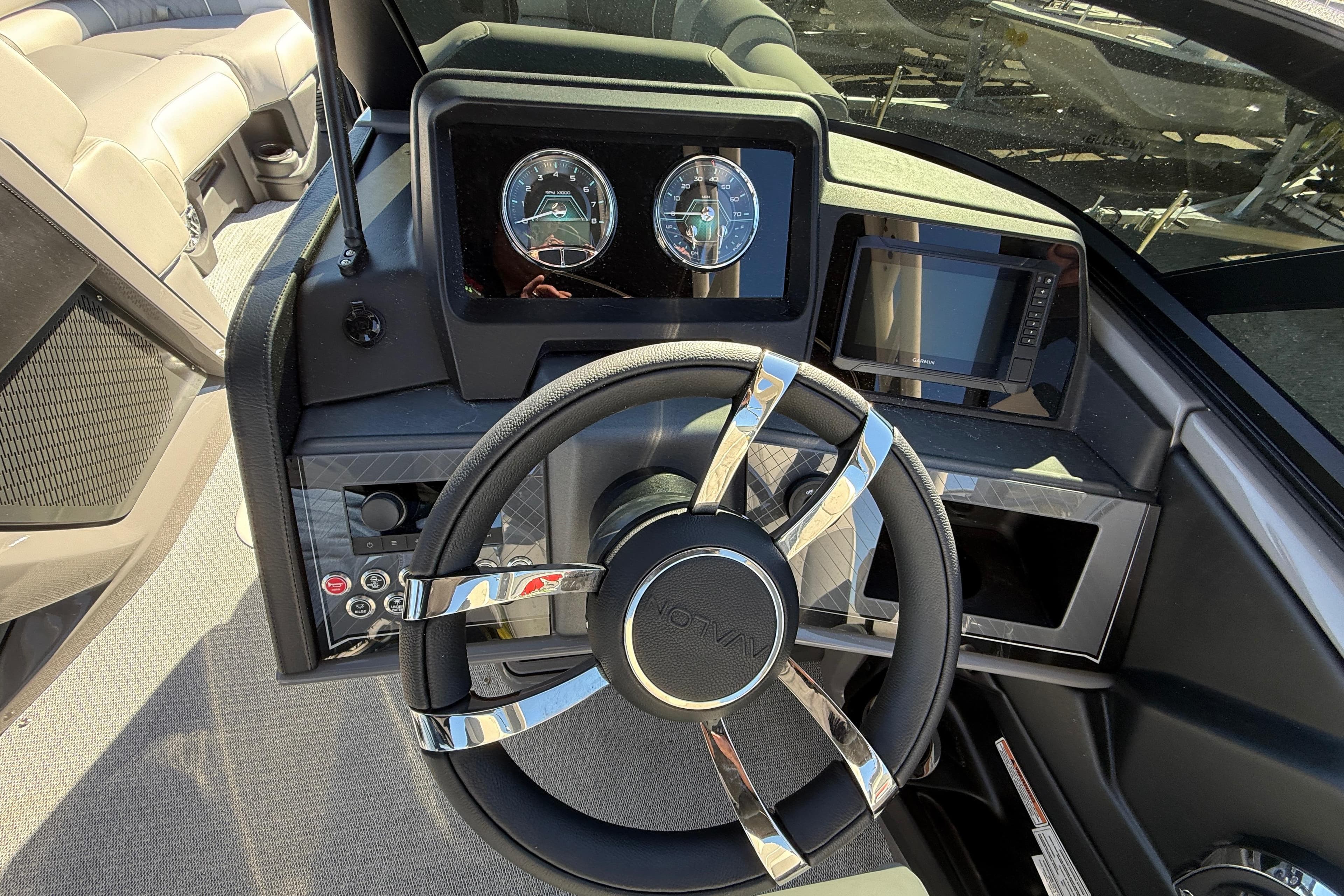 Steering console of 2026 Avalon 2385 Catalina Windshield Quade Lounger, featuring modern controls.