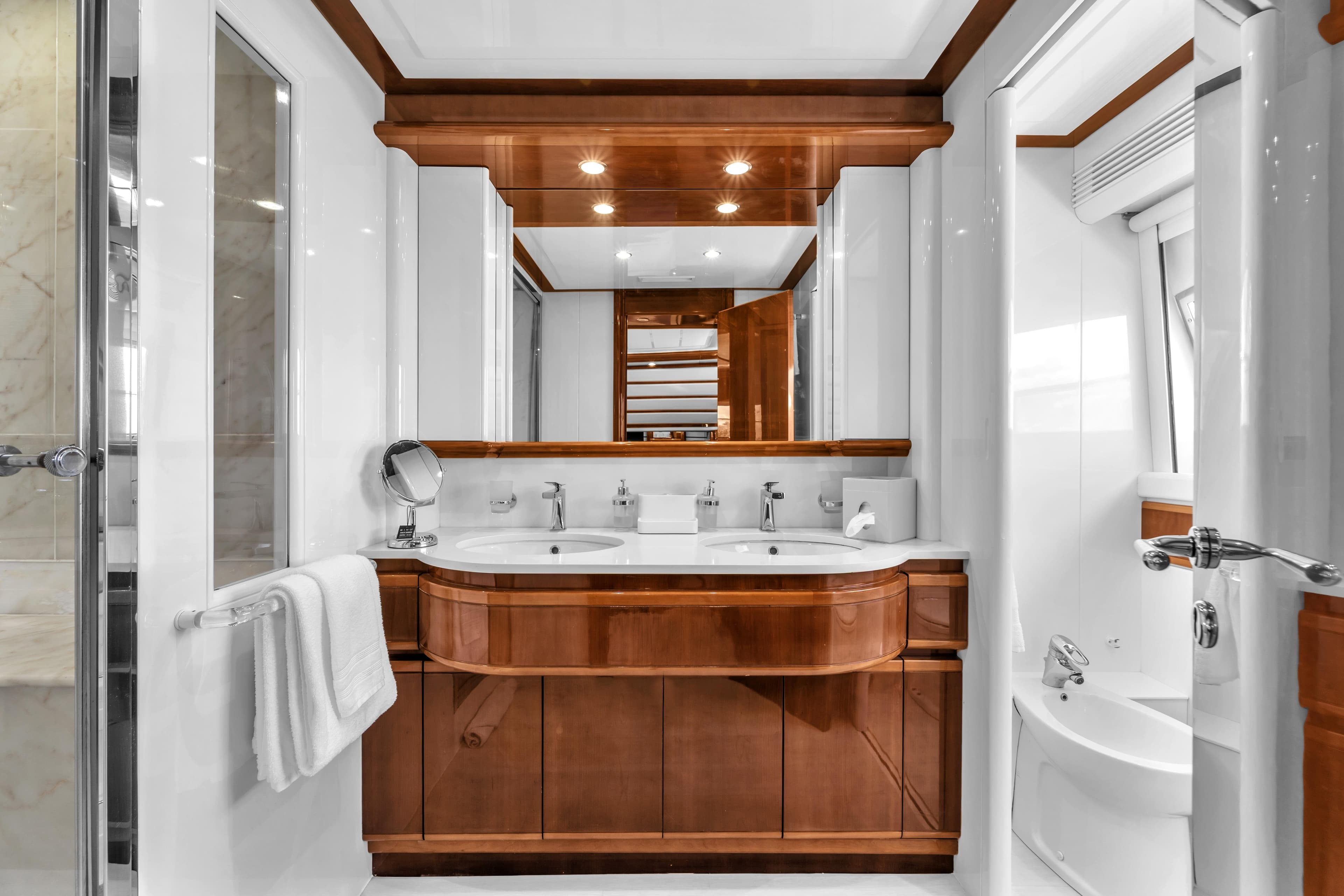 Luxurious bathroom in 2002 Ferretti Yachts Custom Line 94, featuring elegant wood finishes.