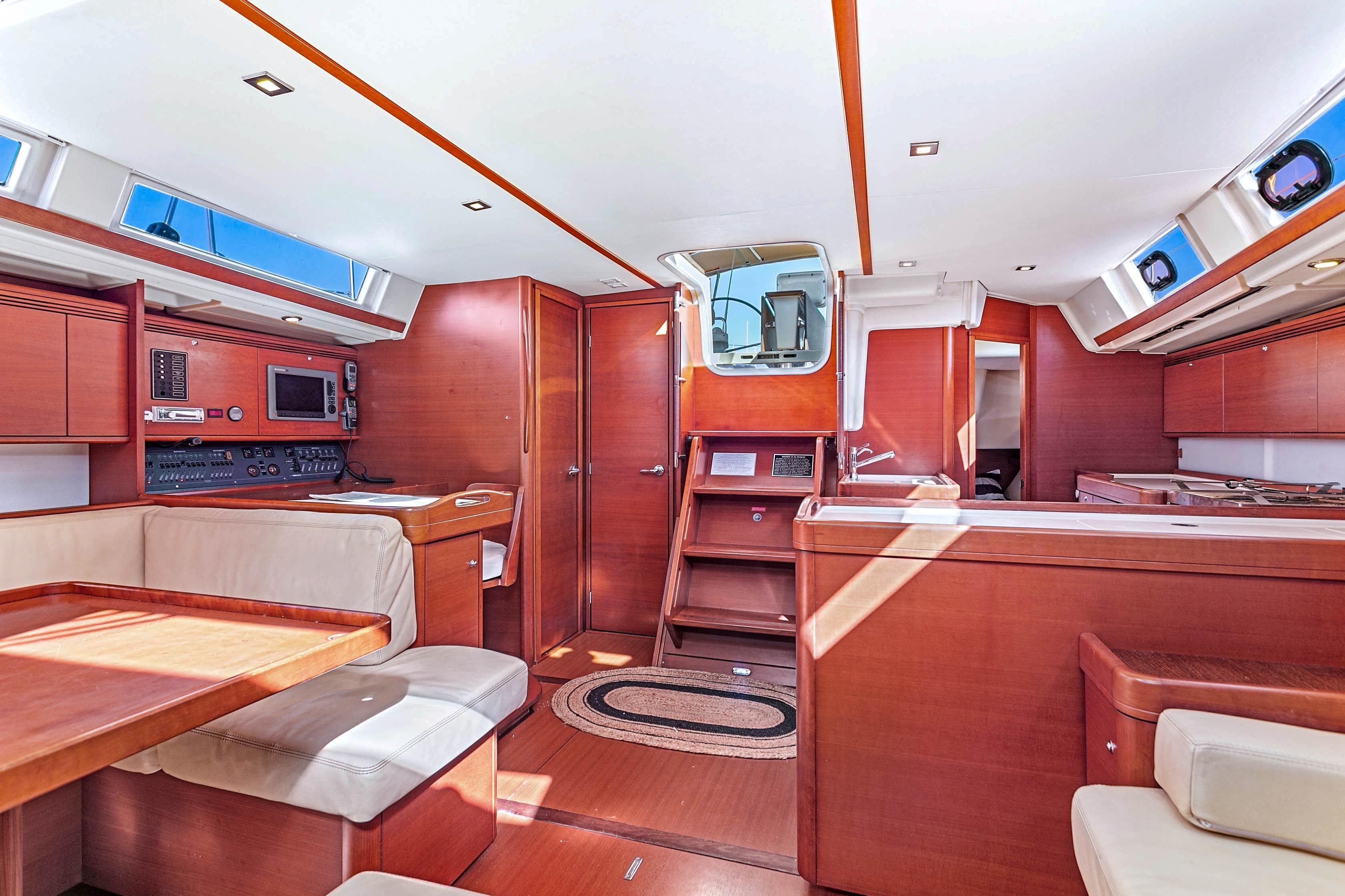 Luxurious interior of 2011 Dufour 525 Grand Large yacht with wood finish and modern amenities.