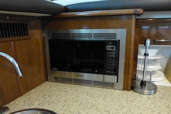 2009 Carver 41 Cockpit Motor Yacht kitchen with built-in microwave and countertop.