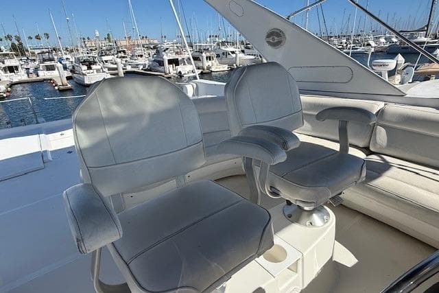 2001 Bayliner 5288 Pilot House Motoryacht helm seats with marina view.