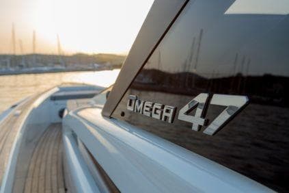 2023 Technohull Omega 47 yacht, sleek design, docked at sunset.