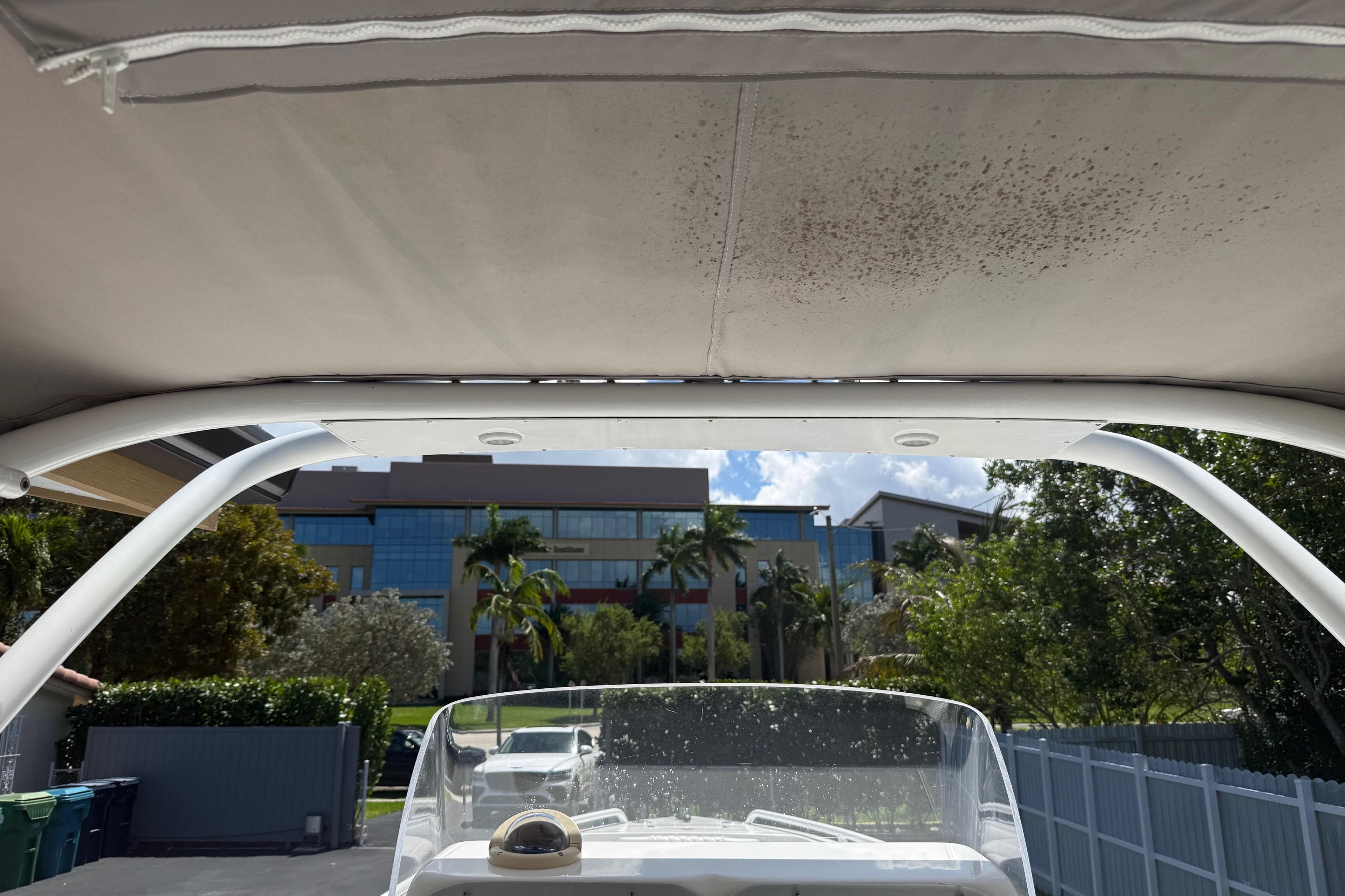 Boat canopy view with modern building and trees in the background, Concept 27, 2015 model.