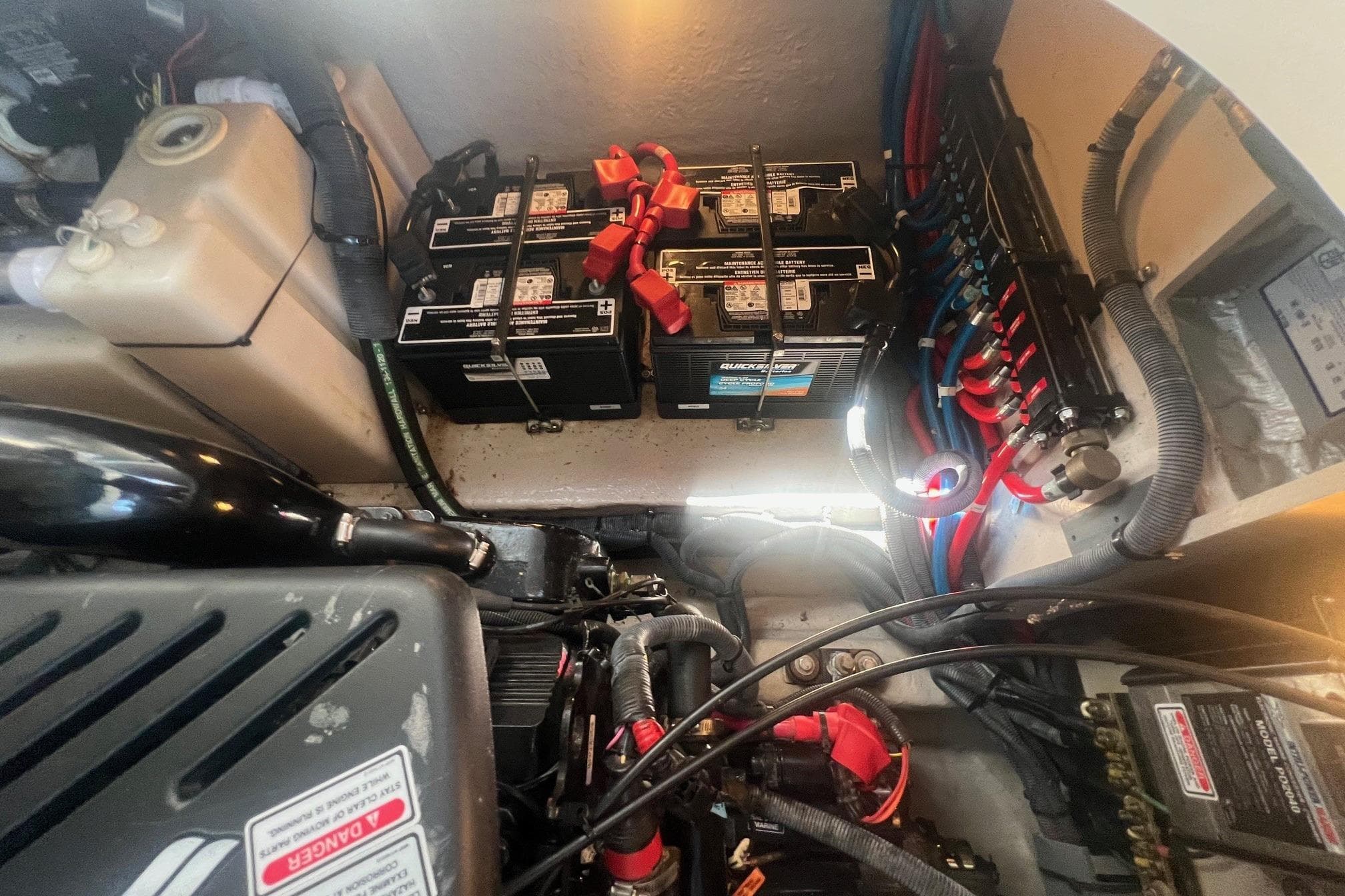 Engine compartment of a 2005 Sea Ray 360 Sundancer with batteries and wiring.