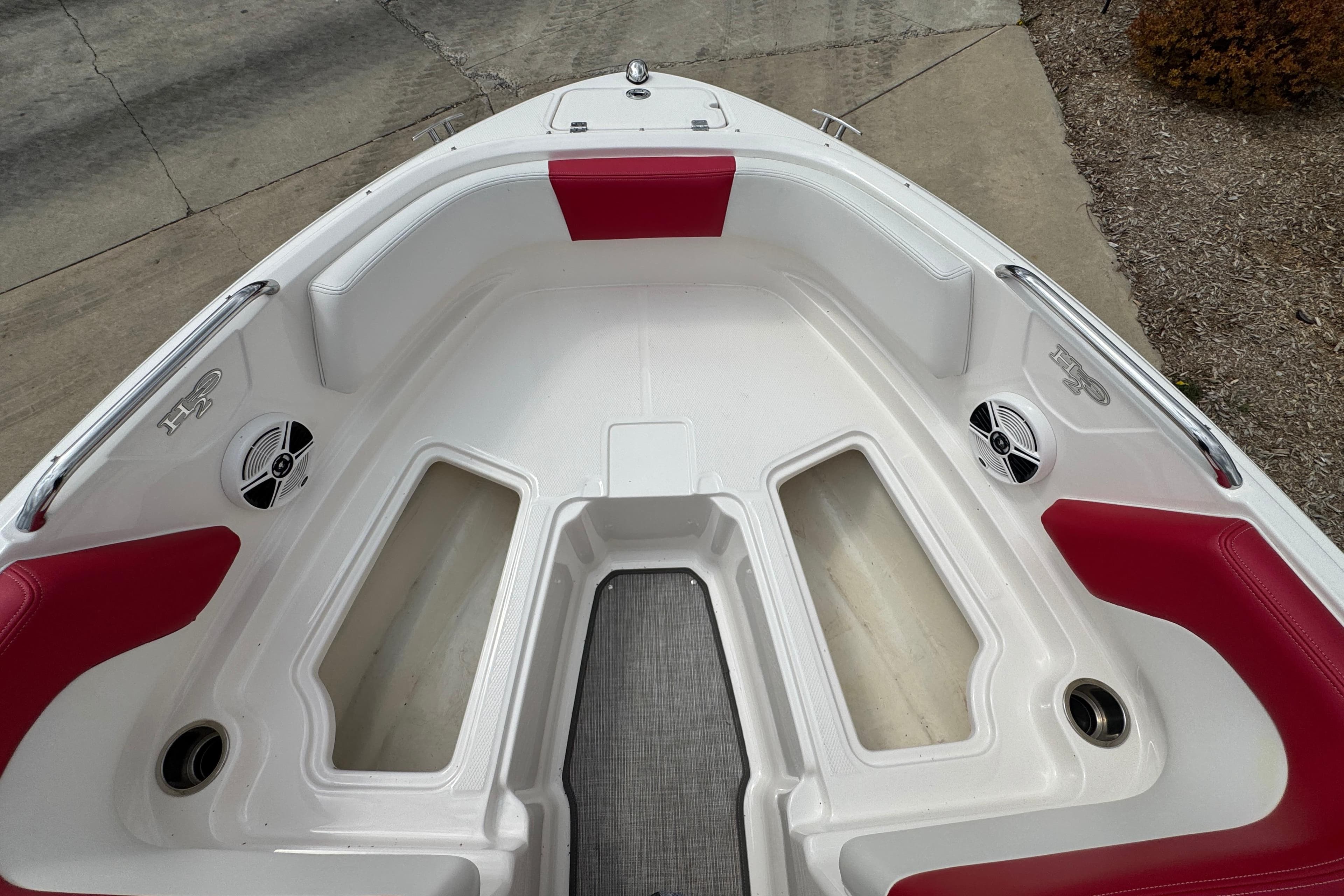 Bow seating area of 2017 Chaparral 21 H2O Sport with red and white upholstery.
