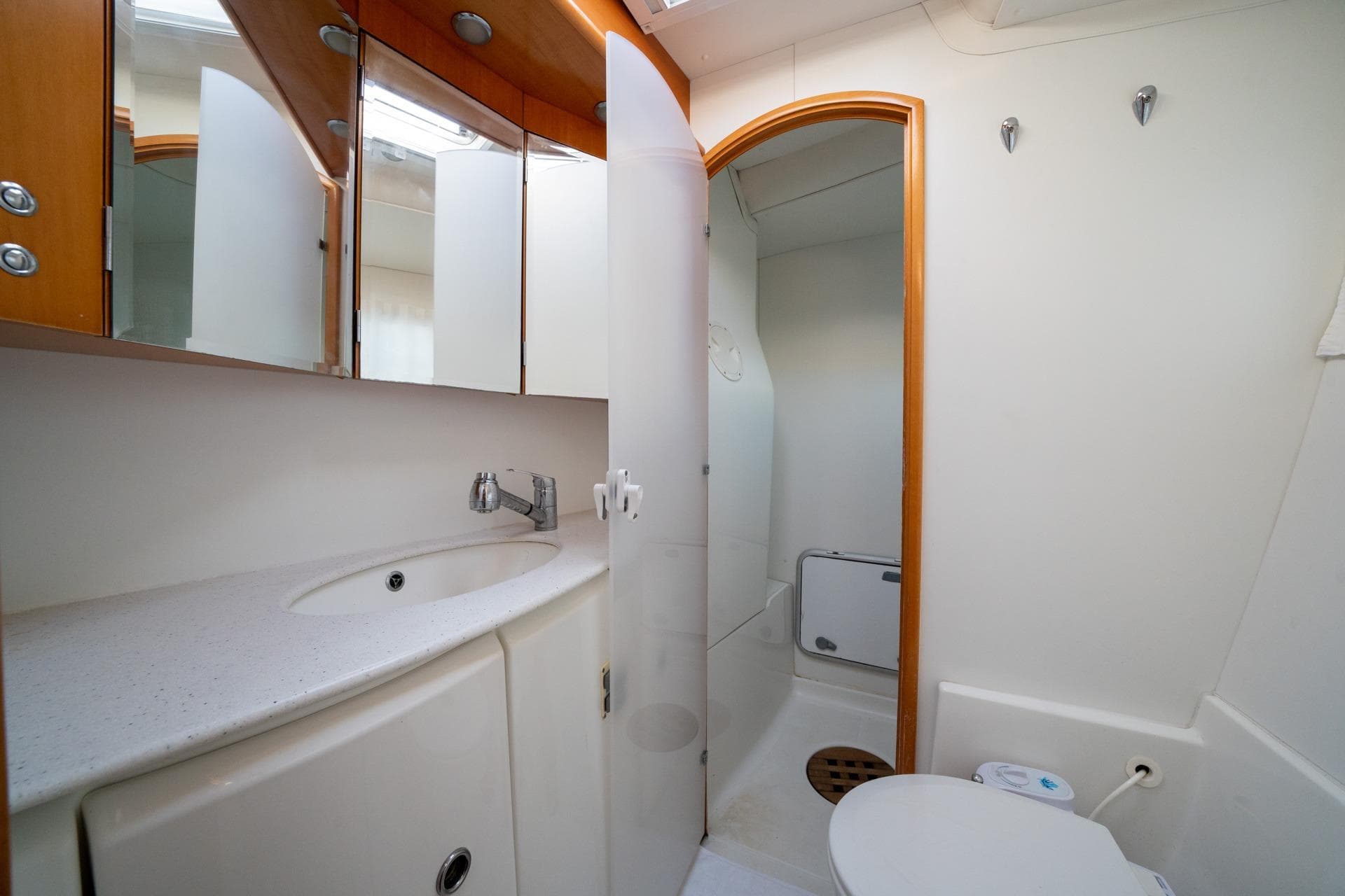 Bathroom interior of 2005 Lagoon 440 yacht with sink, mirror, and toilet.