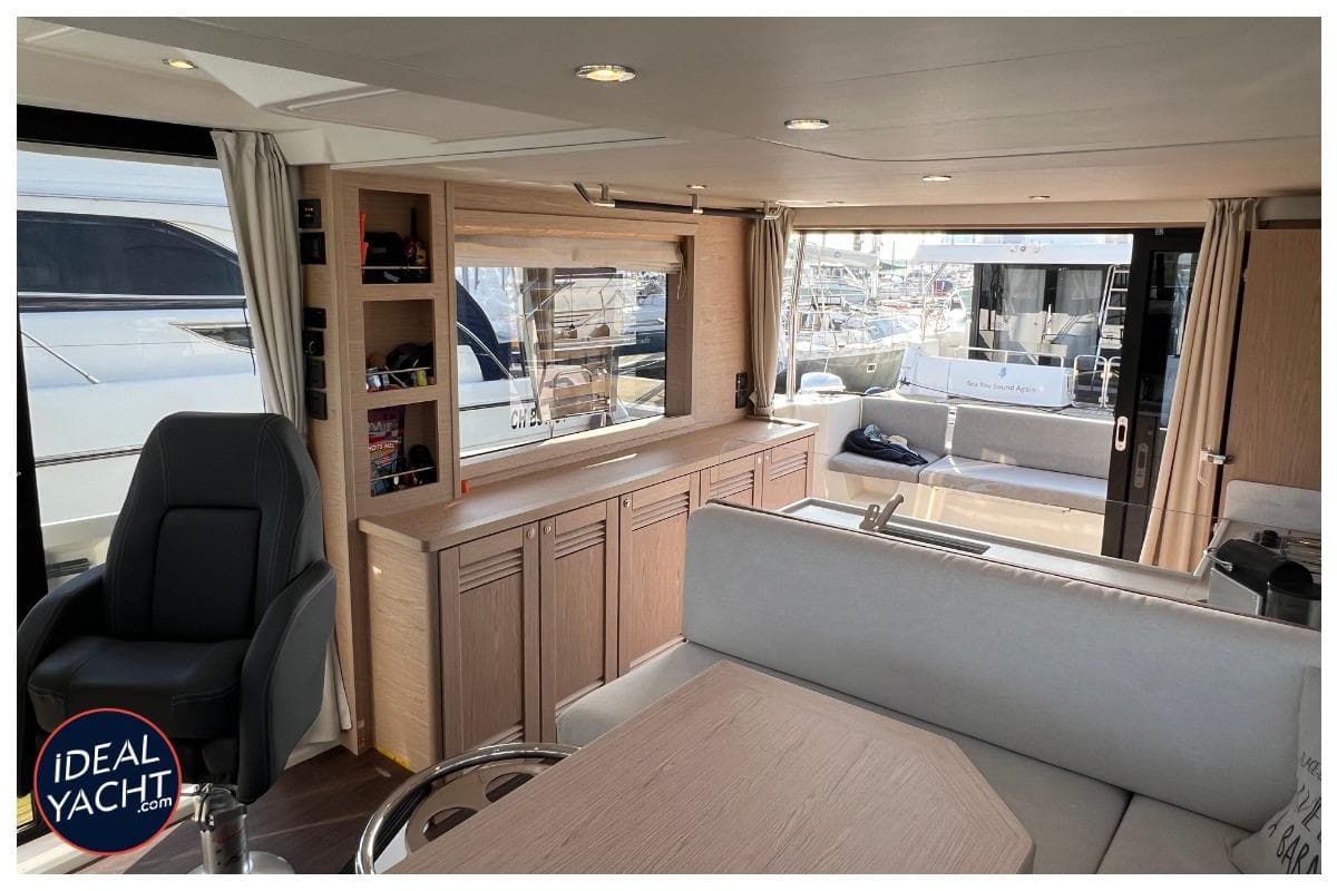 Interior of 2023 Beneteau Swift Trawler 48 yacht, featuring modern seating and cabinetry.