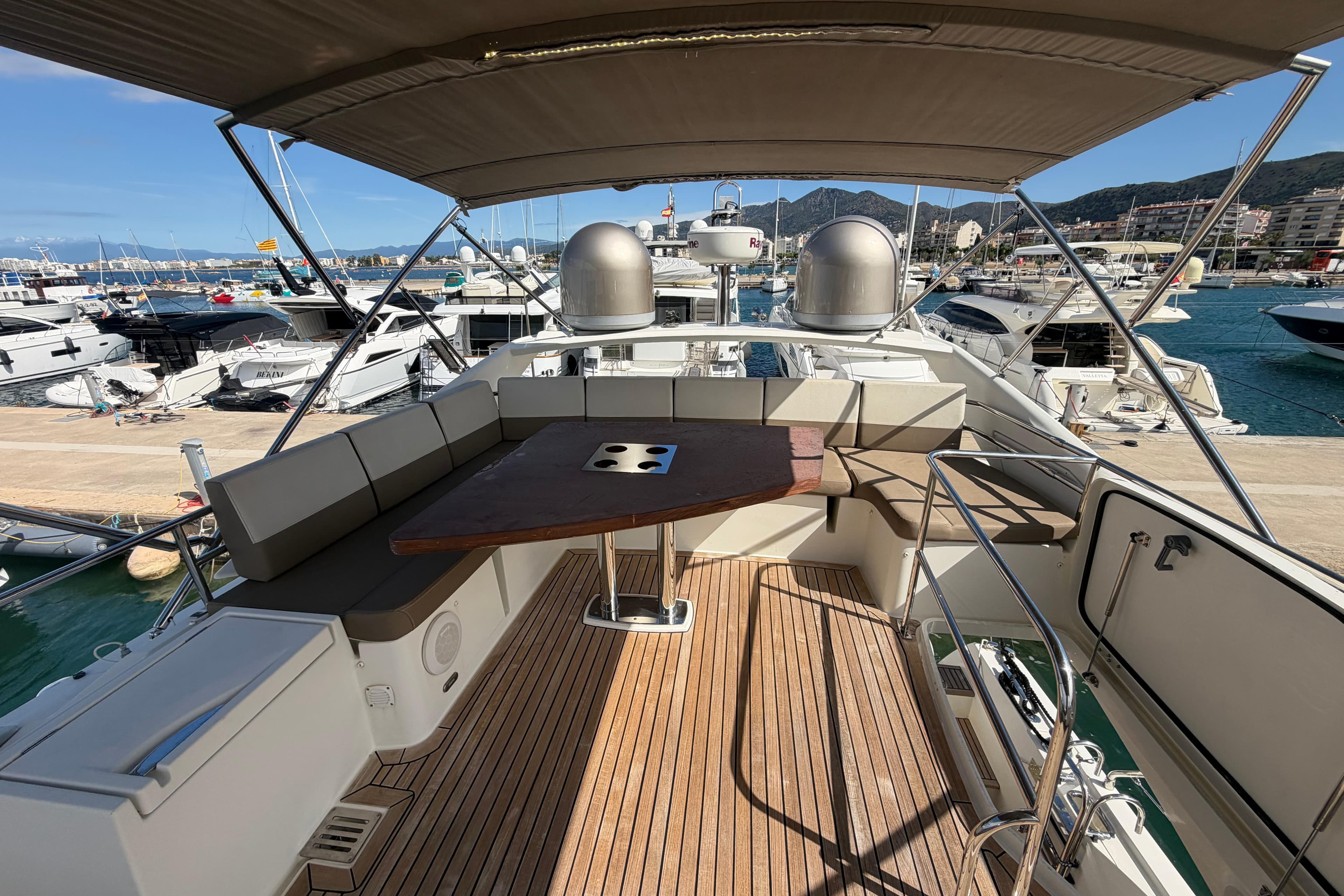 Luxurious 2015 Prestige 550 yacht deck with seating, docked at marina.