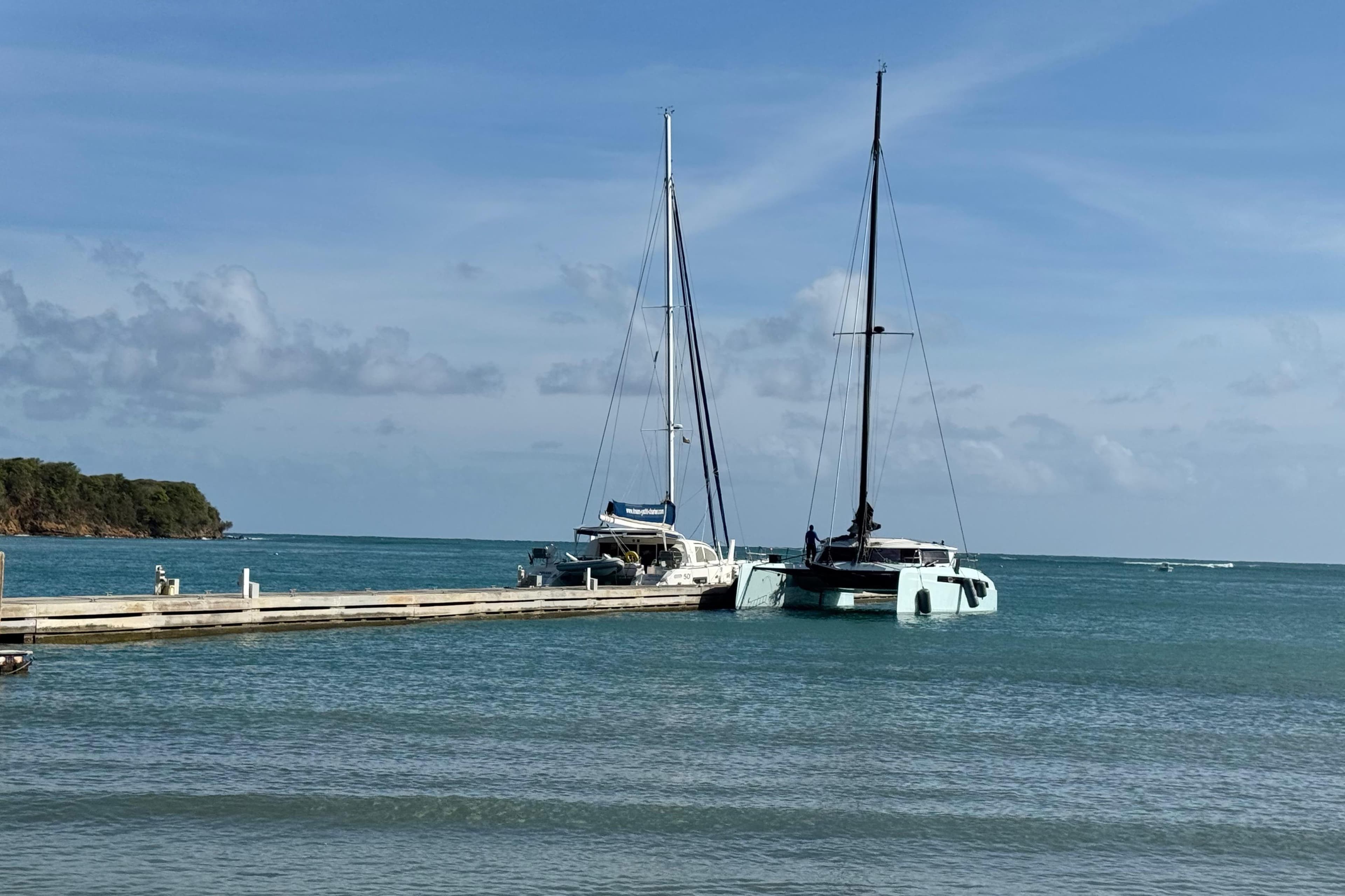 Two sailboats docked at a pier on a sunny day, Alibi 54 model, 2011.
