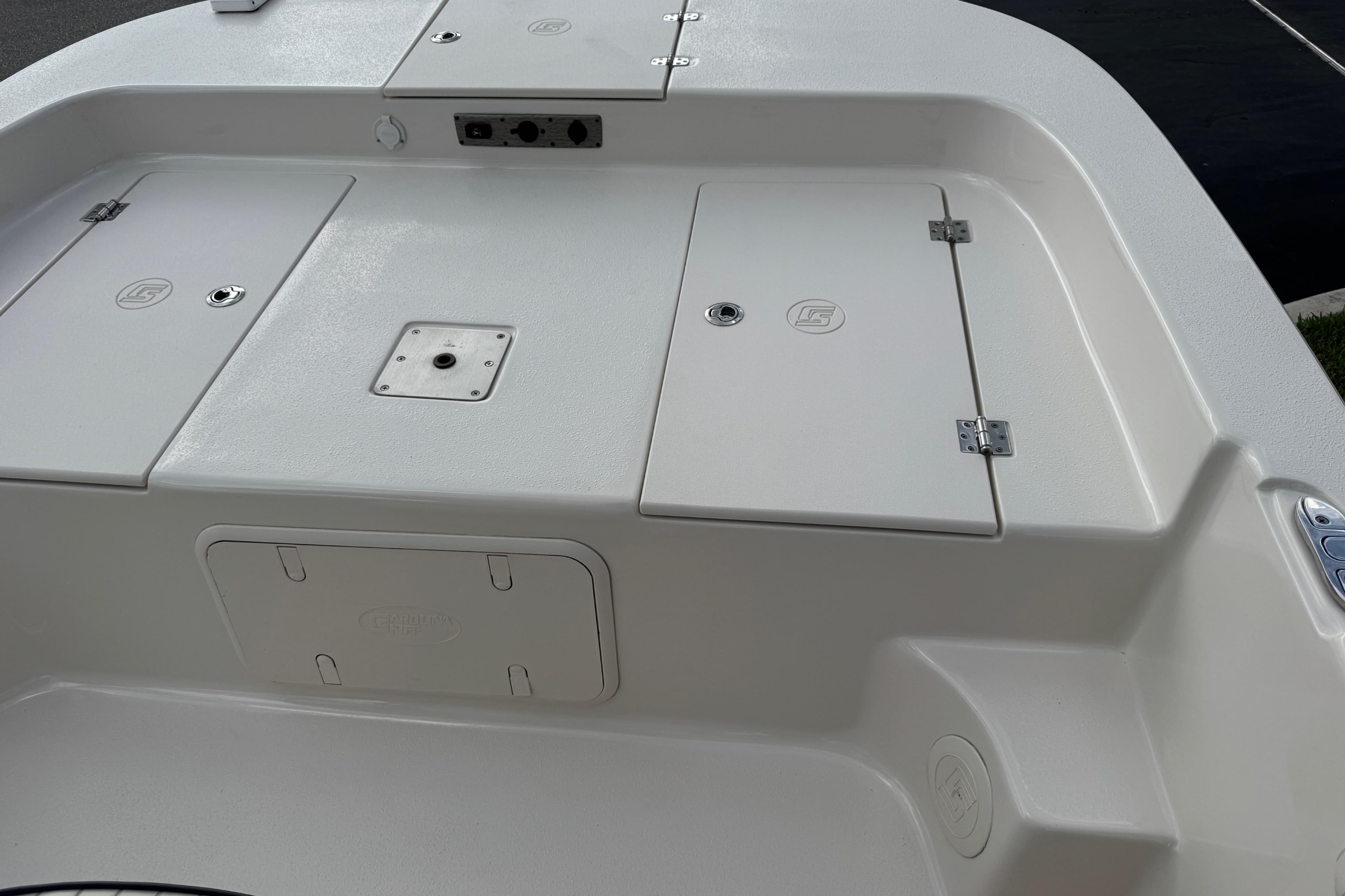 2022 Carolina Skiff 19 LS boat deck with storage compartments and mounting point.