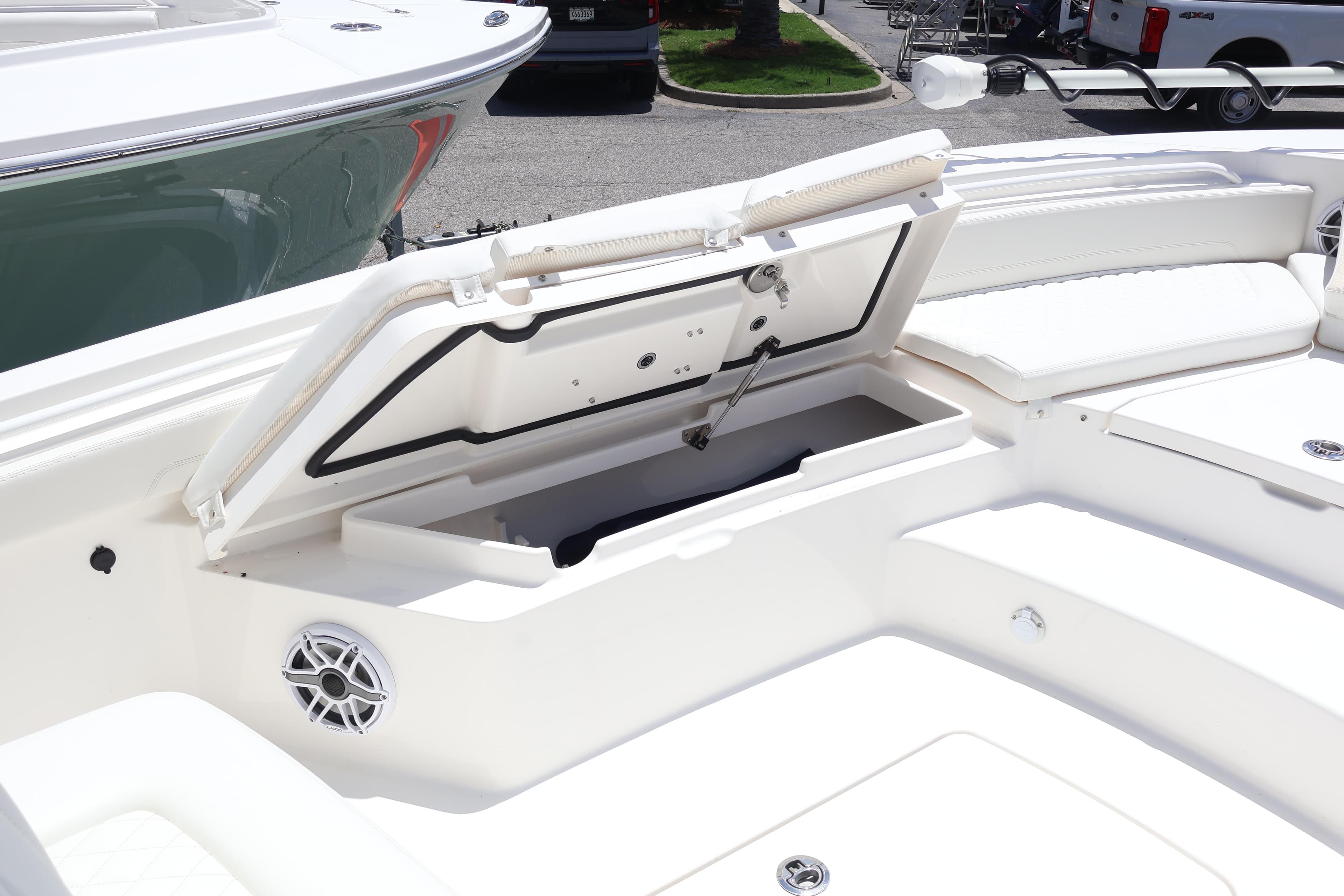 Open storage compartment on 2026 Regulator 25 boat deck.