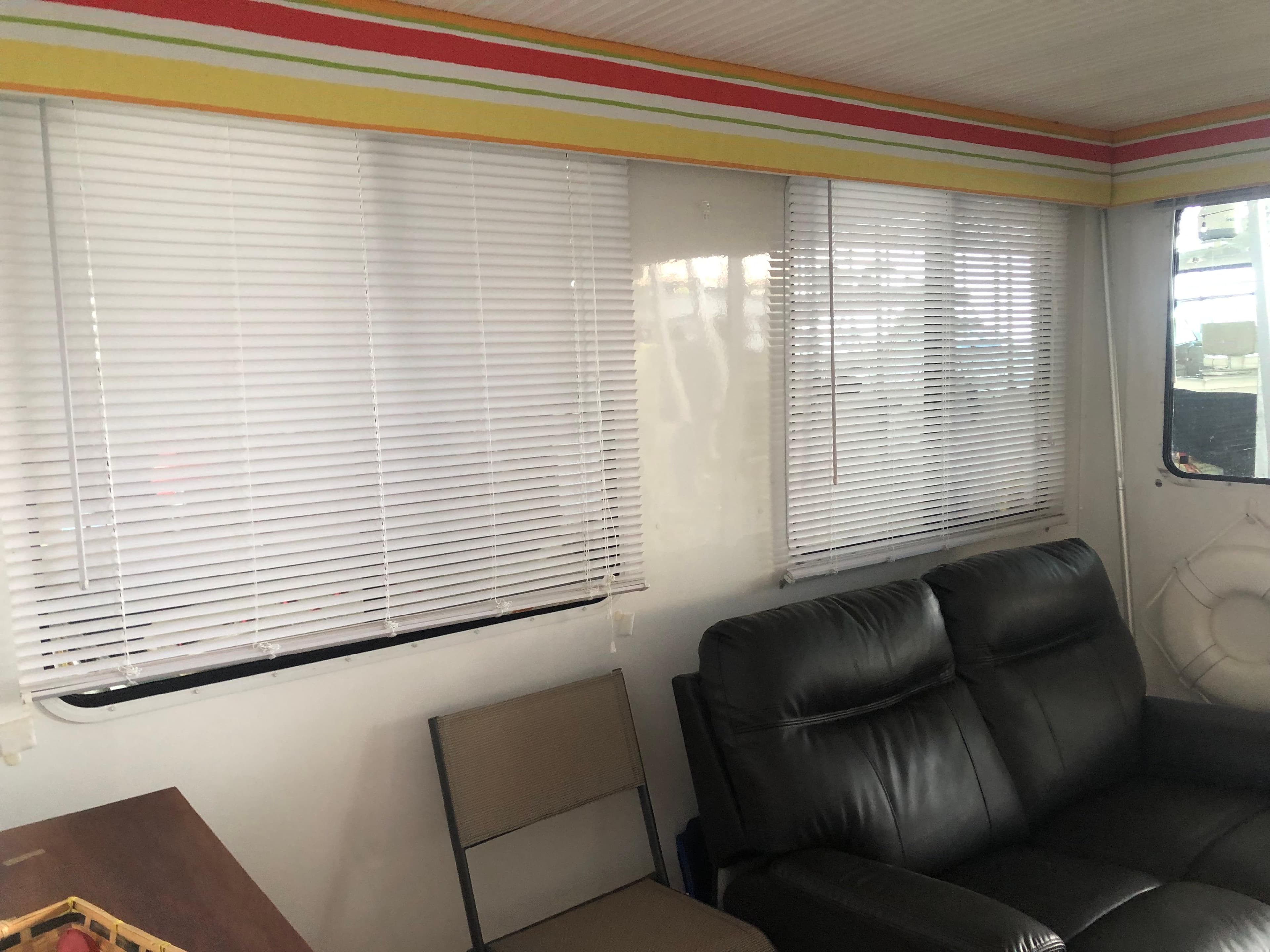 Interior of 2013 Catamaran Cruisers 39 with blinds, leather seating, and colorful trim.