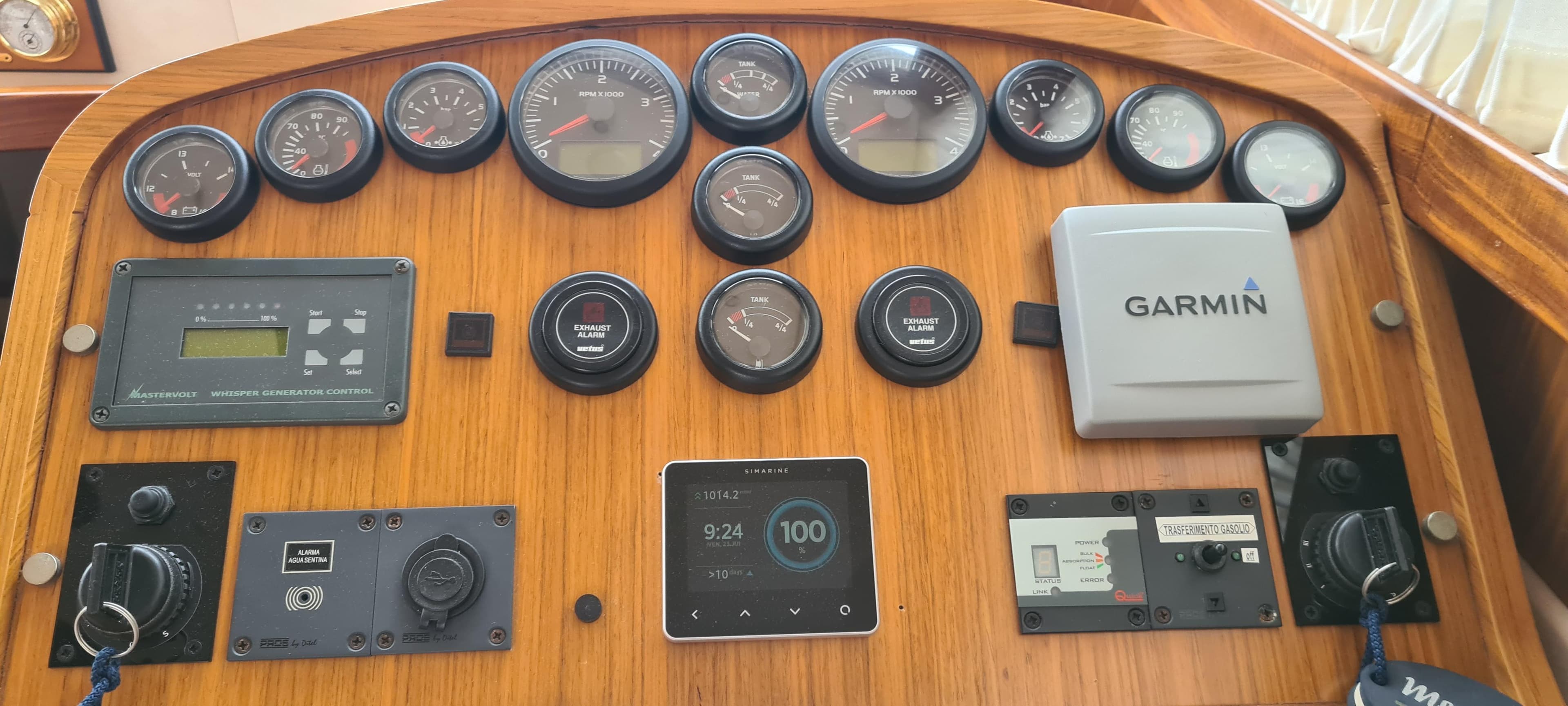 Control panel of a 2007 Menorquin 145 boat with gauges and Garmin device.
