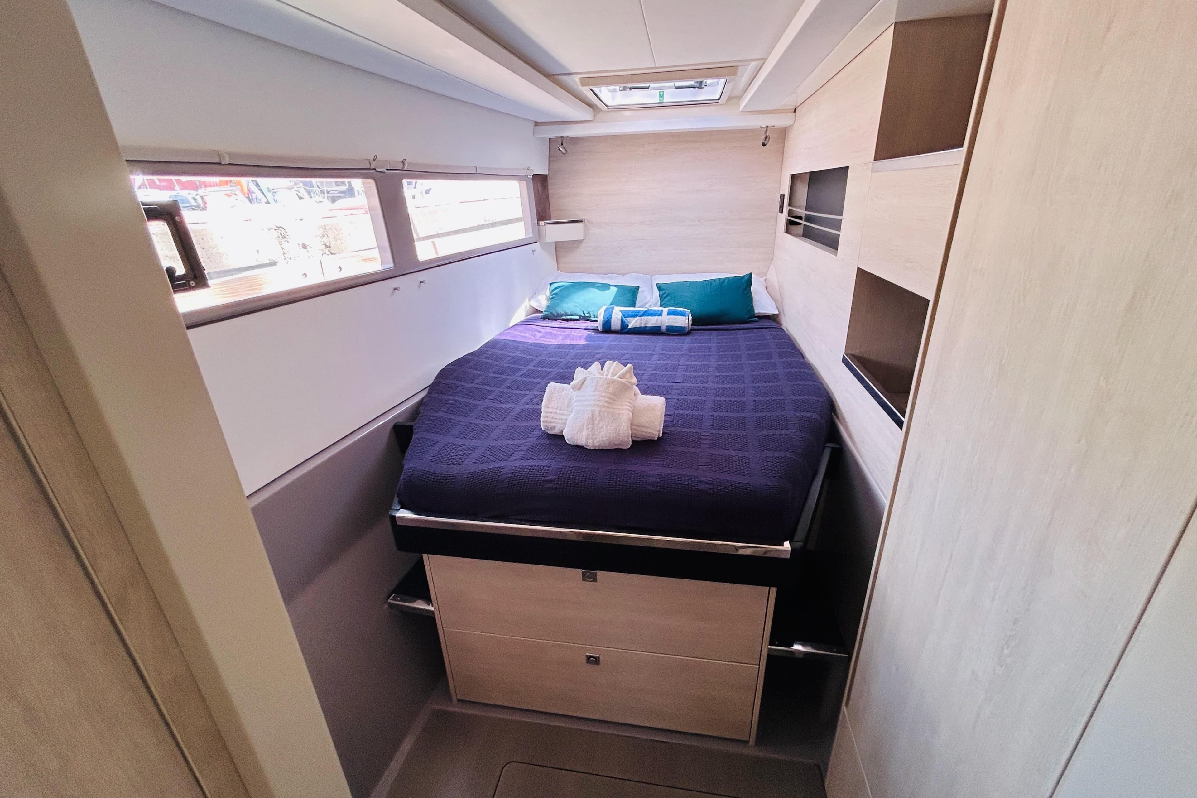 Luxurious cabin interior of 2021 Leopard 45 yacht with cozy bed and modern design.