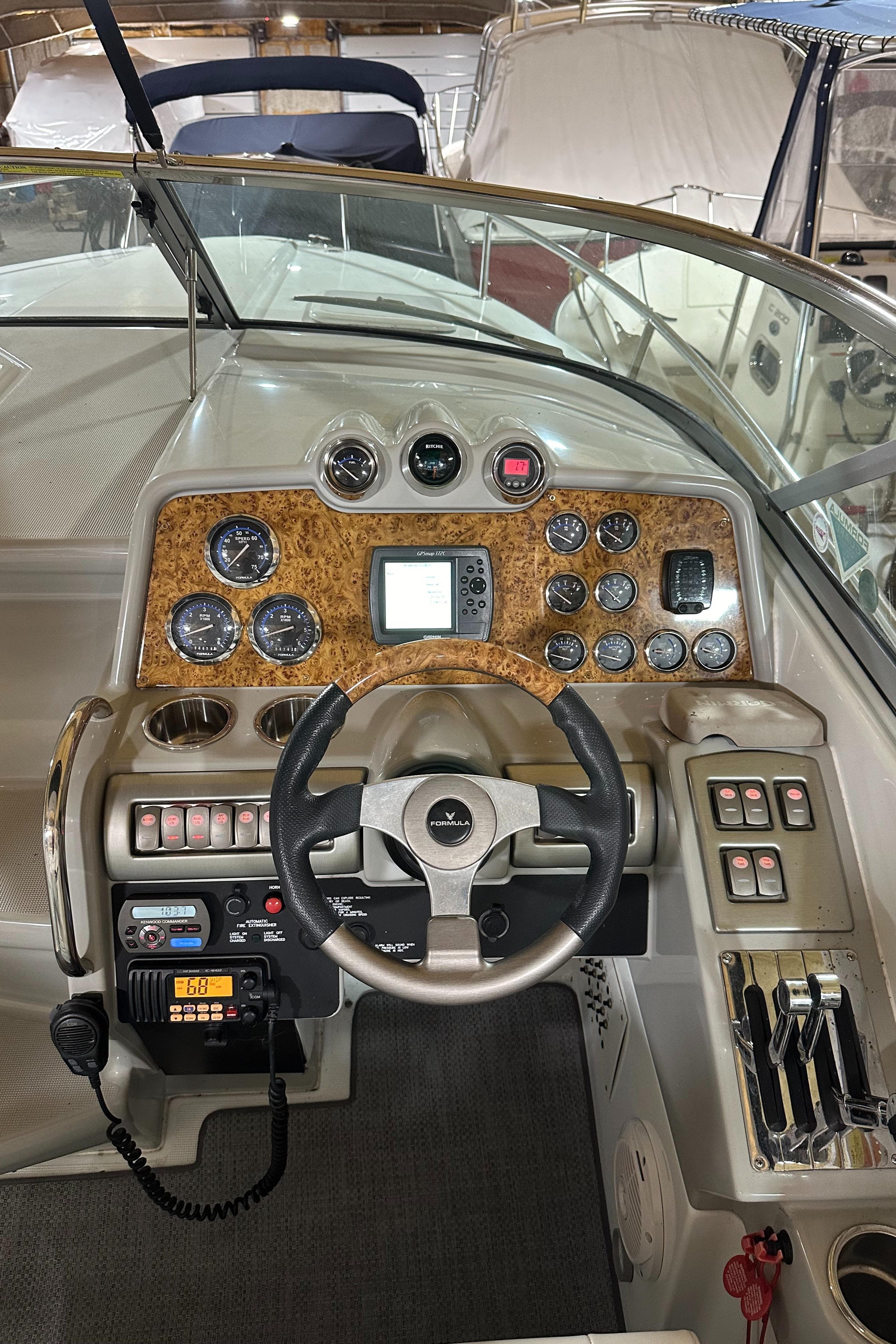 2007 Formula 310 Sun Sport boat dashboard with steering wheel and control panel.