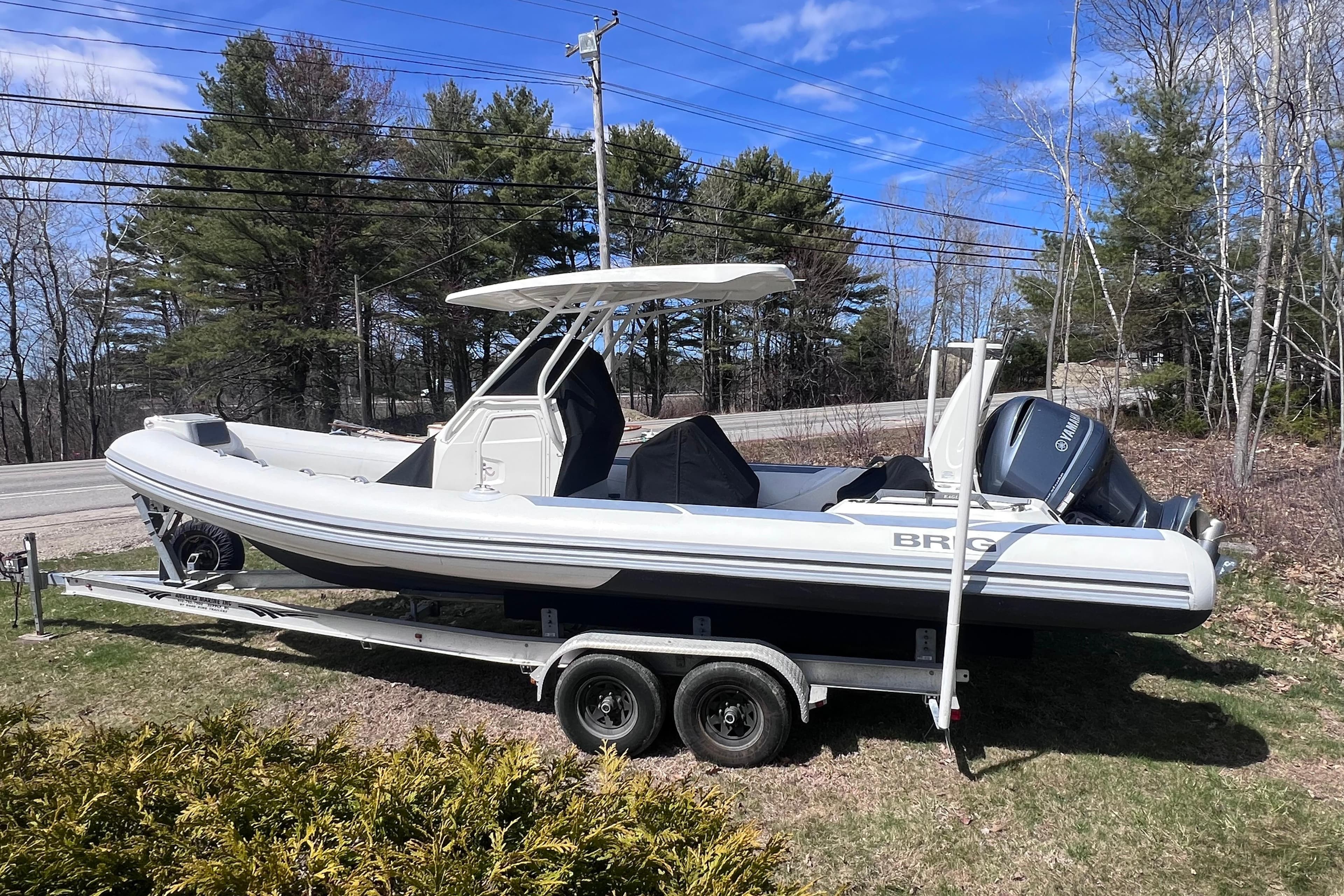 2022 Brig Eagle 8 boat on trailer, parked outdoors with trees in background.