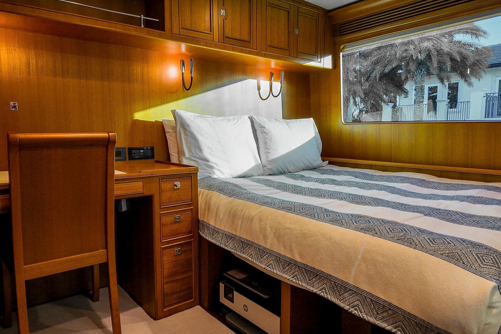 Luxurious cabin interior of 2022 Marlow Voyager Series yacht with wooden furnishings.