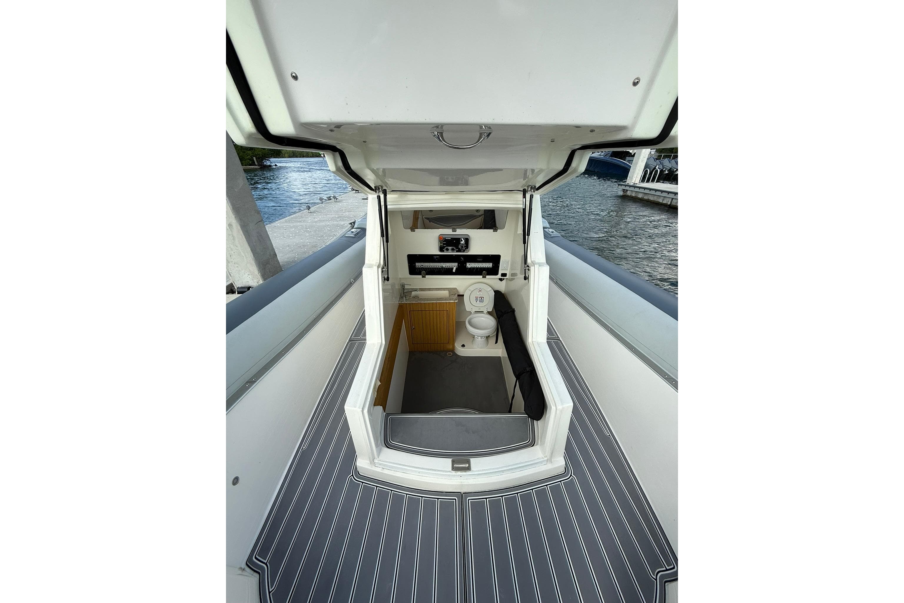 RIB CVL Colt 35 boat interior with toilet, docked by the water, 2018 model.