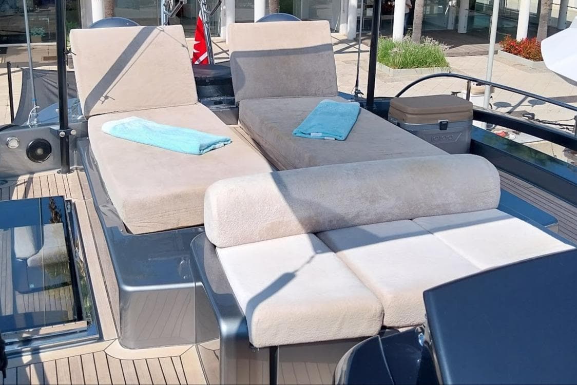 Luxurious sun loungers on 2010 Riva 86 Domino yacht deck with towels.