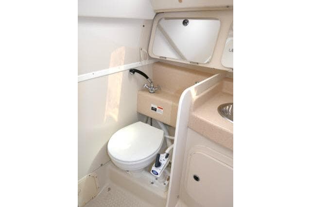 2001 Catalina 310 boat bathroom with toilet, sink, and mirror.
