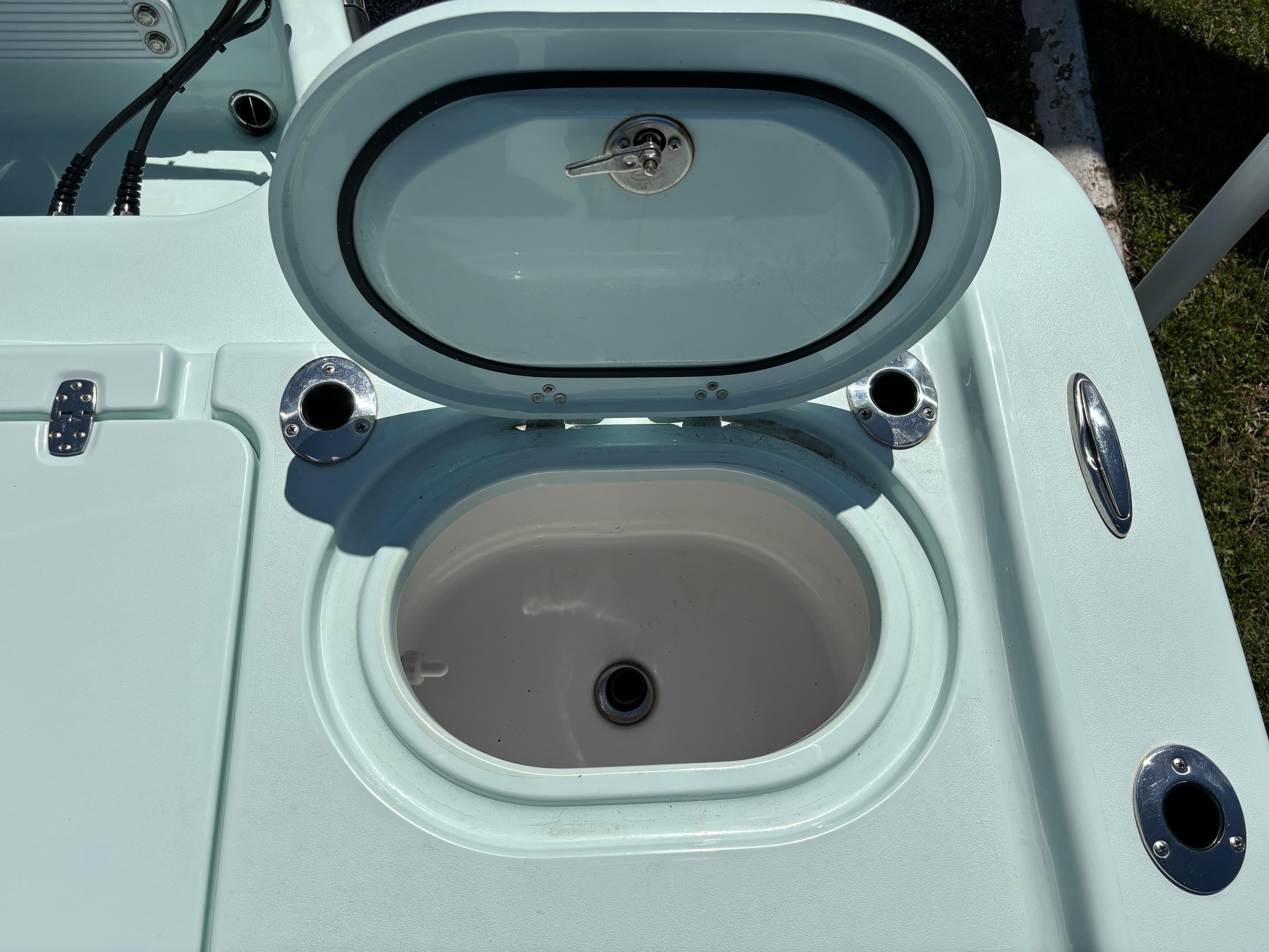 Open hatch on 2024 Clark Sound 24 boat, revealing storage compartment.
