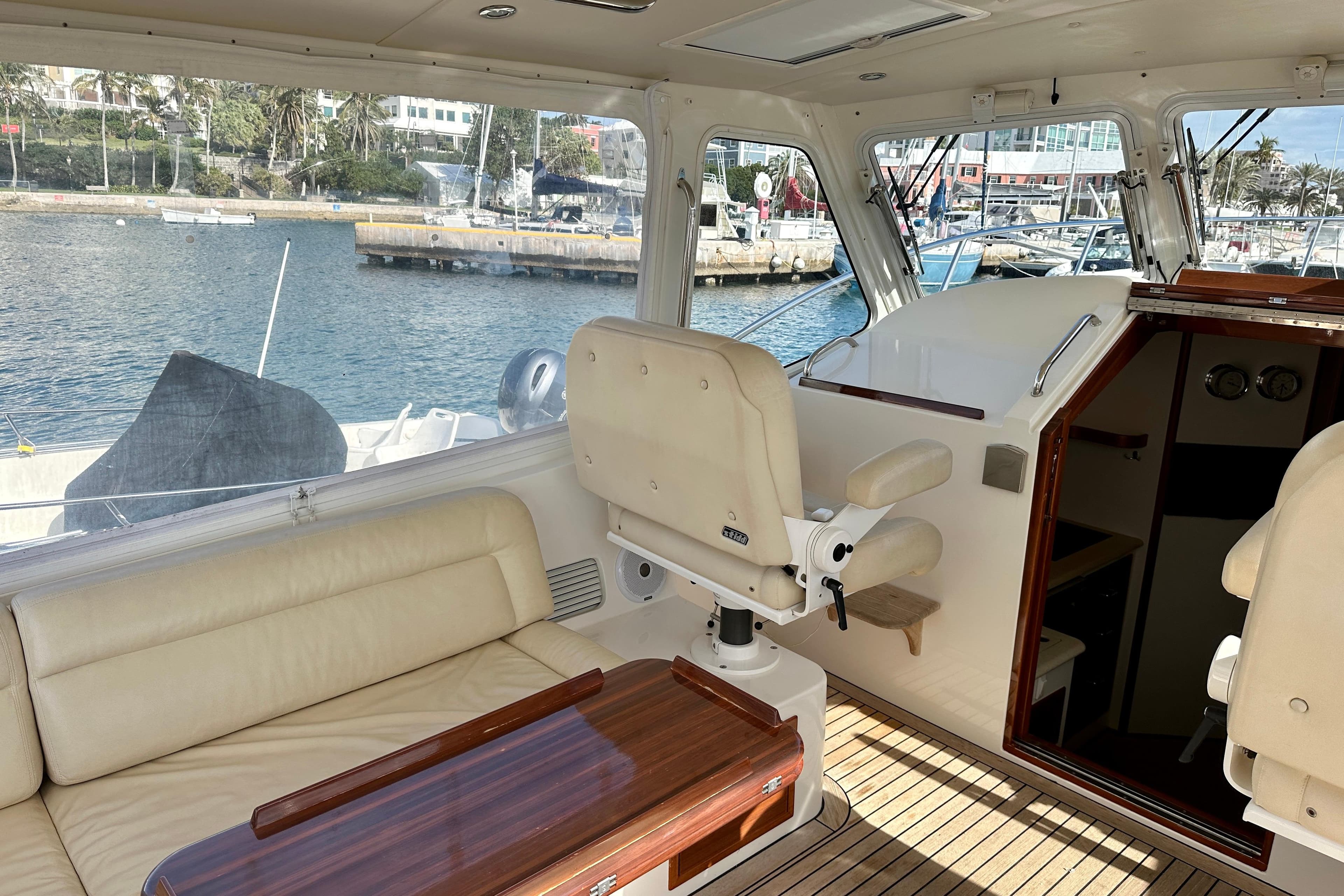 Interior of 2014 MJM 40z yacht with seating and helm, docked at marina.