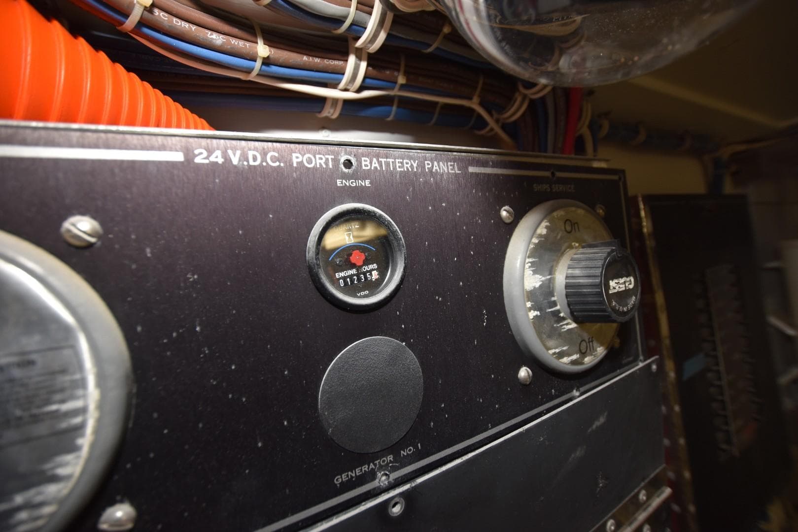 Control panel of a 1998 Hatteras 74 Sport Deck yacht, showing battery and engine gauges.