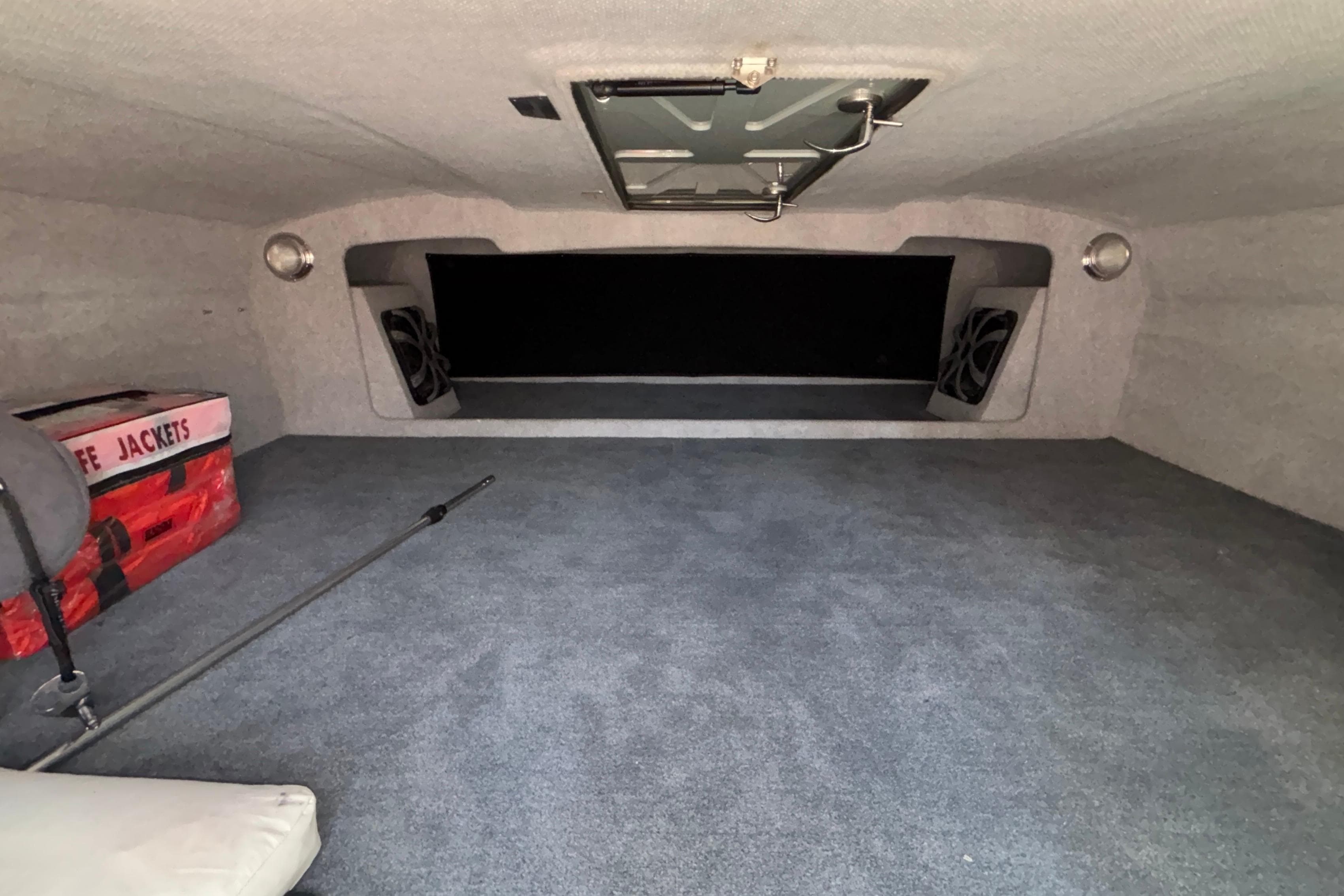 Interior of 2020 Eliminator 36 Daytona Coupe with life jackets and carpeted flooring.