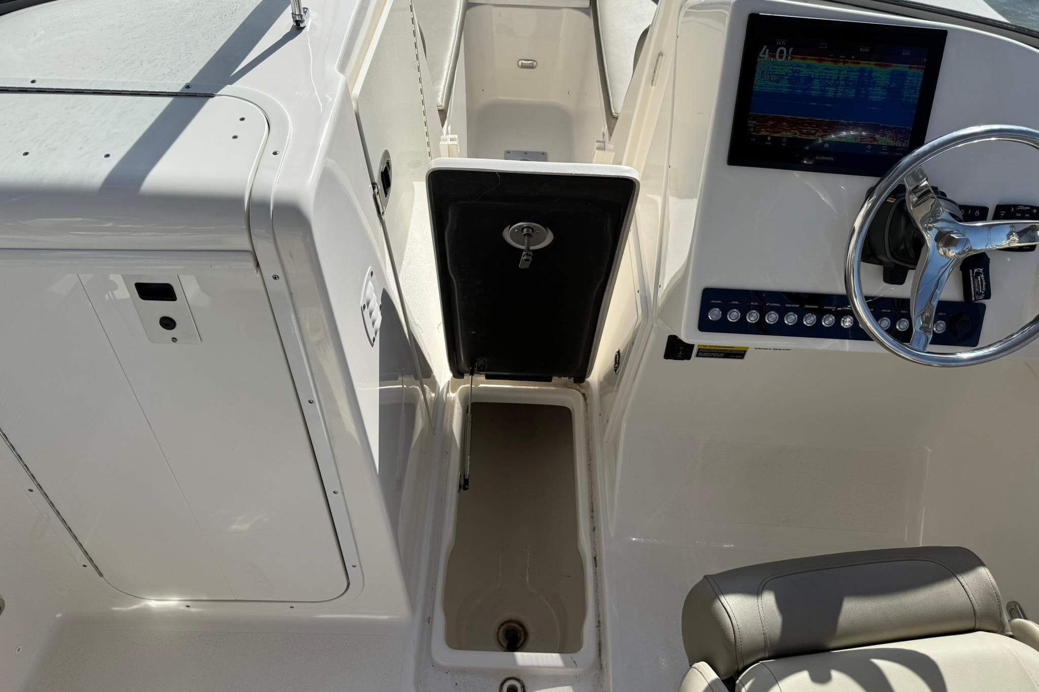 2023 Key West 239 DFS boat interior with steering wheel and control panel.