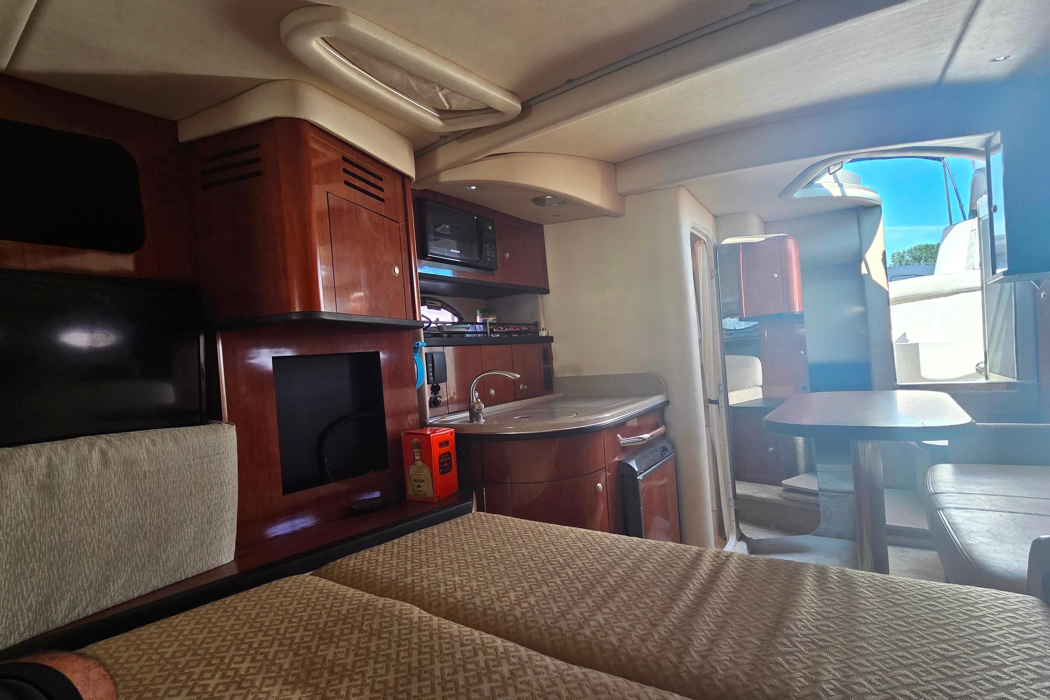 Interior of 2007 Sea Ray 290 Sundancer yacht with kitchenette and seating area.