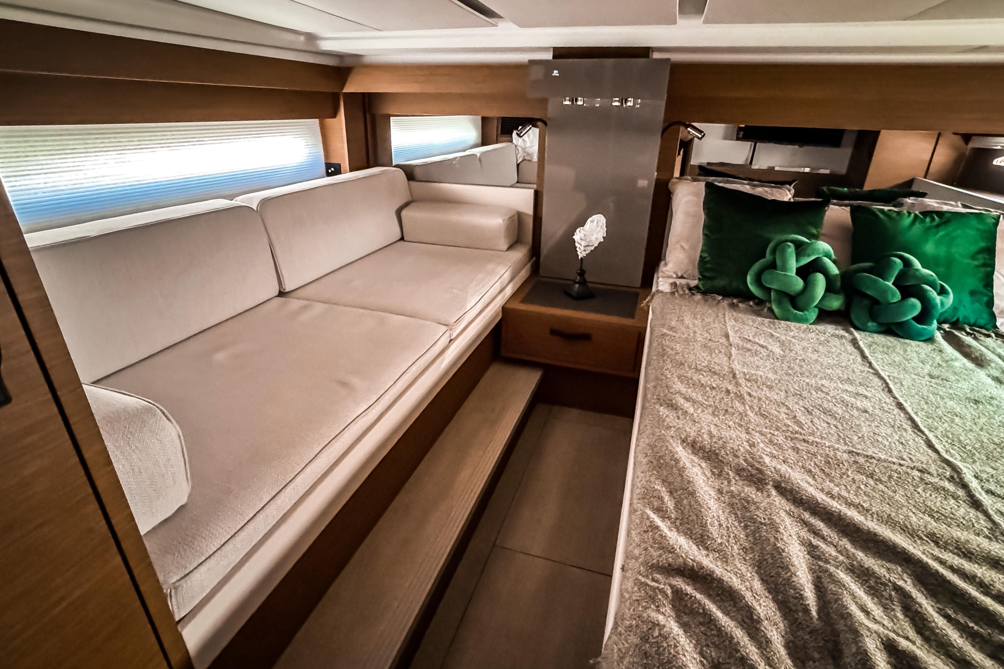 Luxurious interior of 2026 Wellcraft 44 Explorer yacht with elegant seating and bedding.