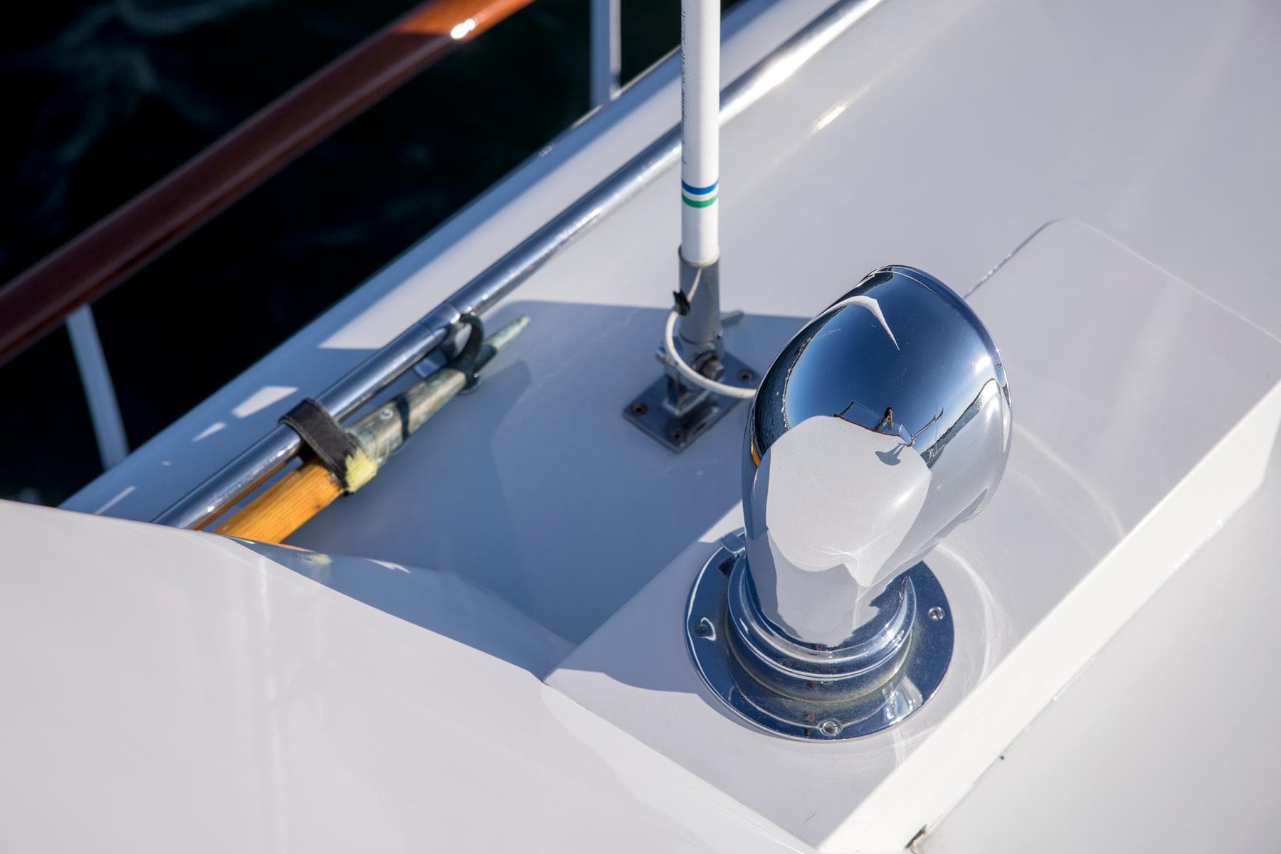 1964 Huckins Out Islander 56 yacht deck detail with chrome vent and railing.