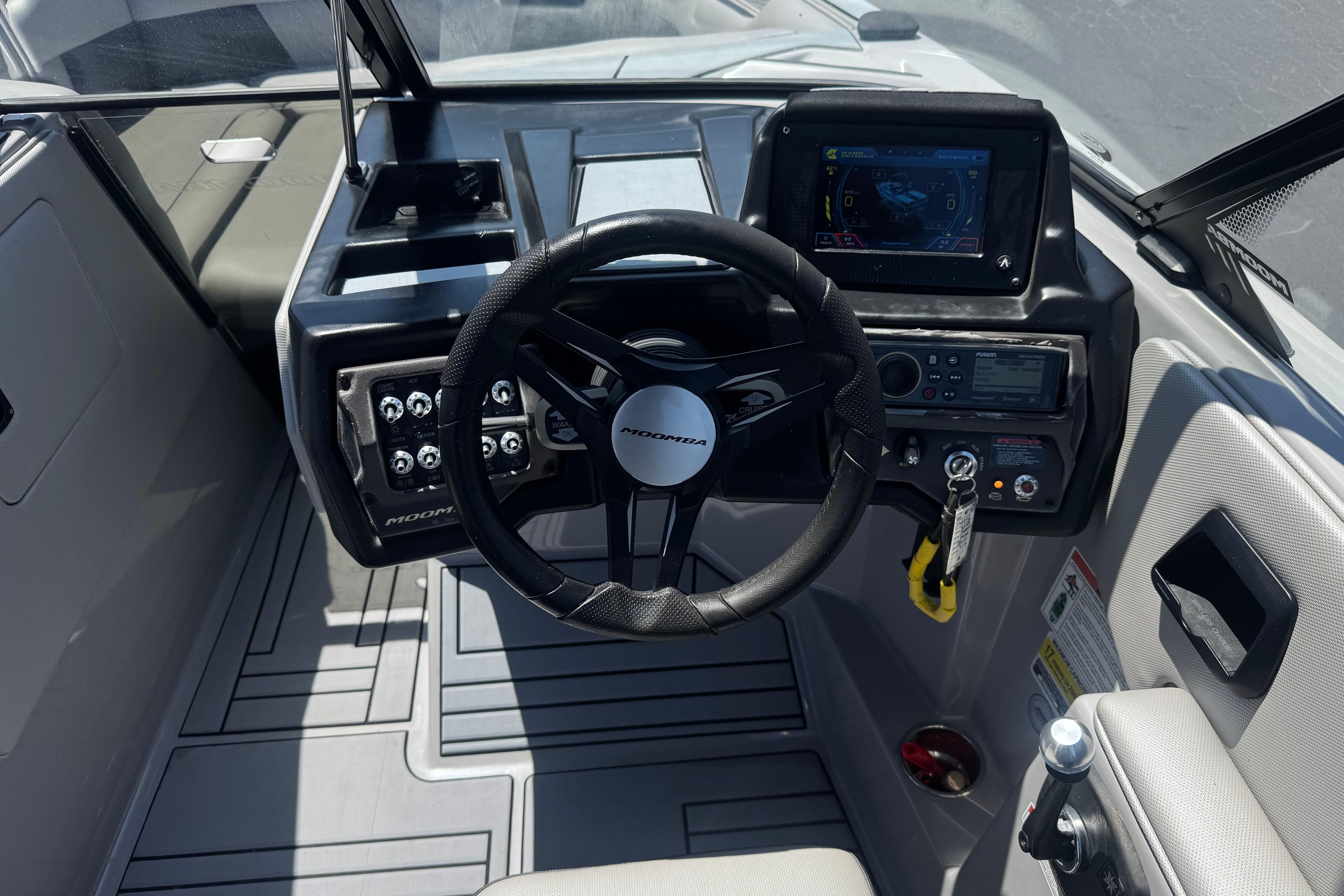 2022 Moomba Max boat dashboard with steering wheel and control panel.