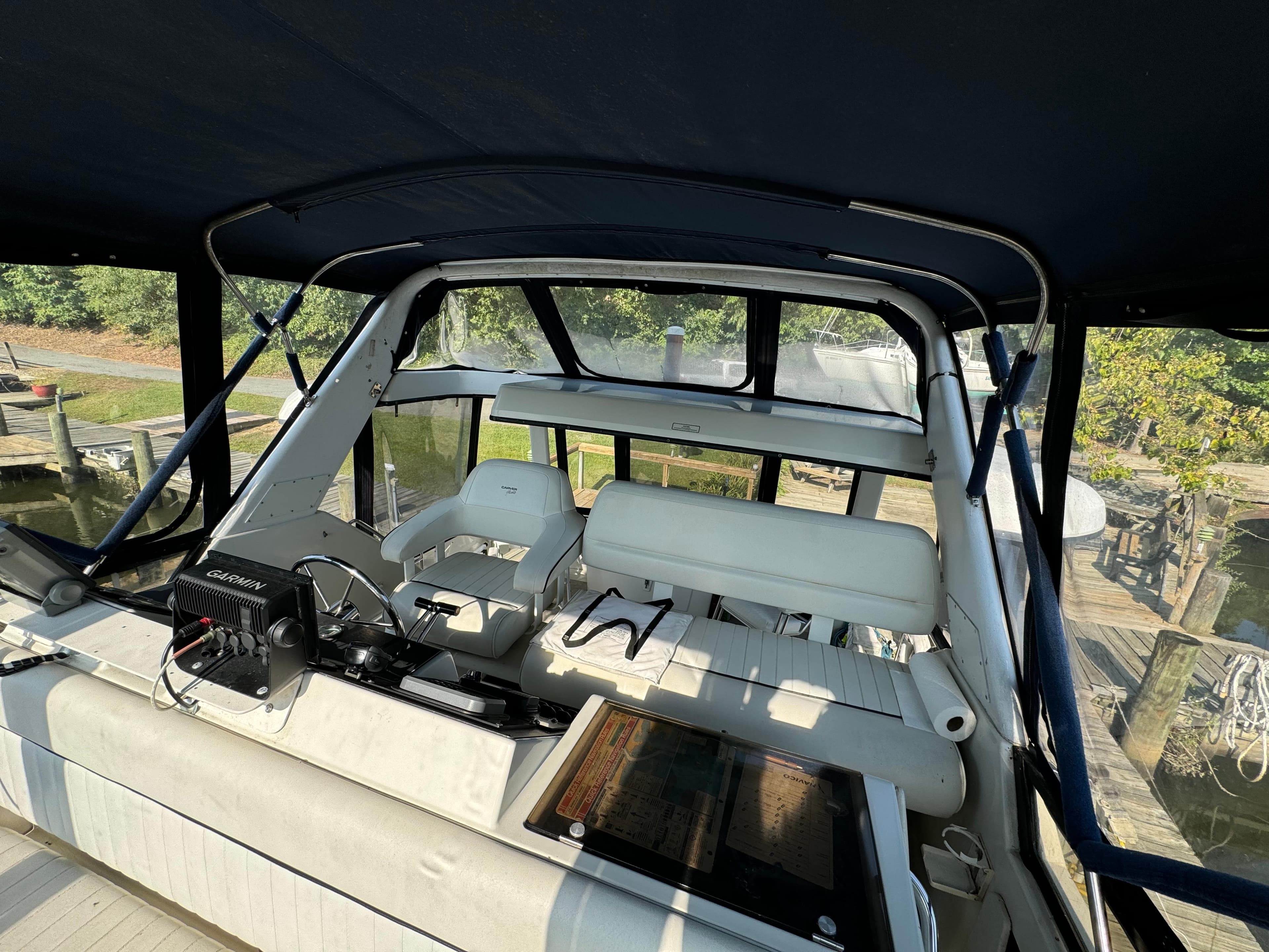 1991 Carver 33 Aft Cabin boat interior with seating and control panel.