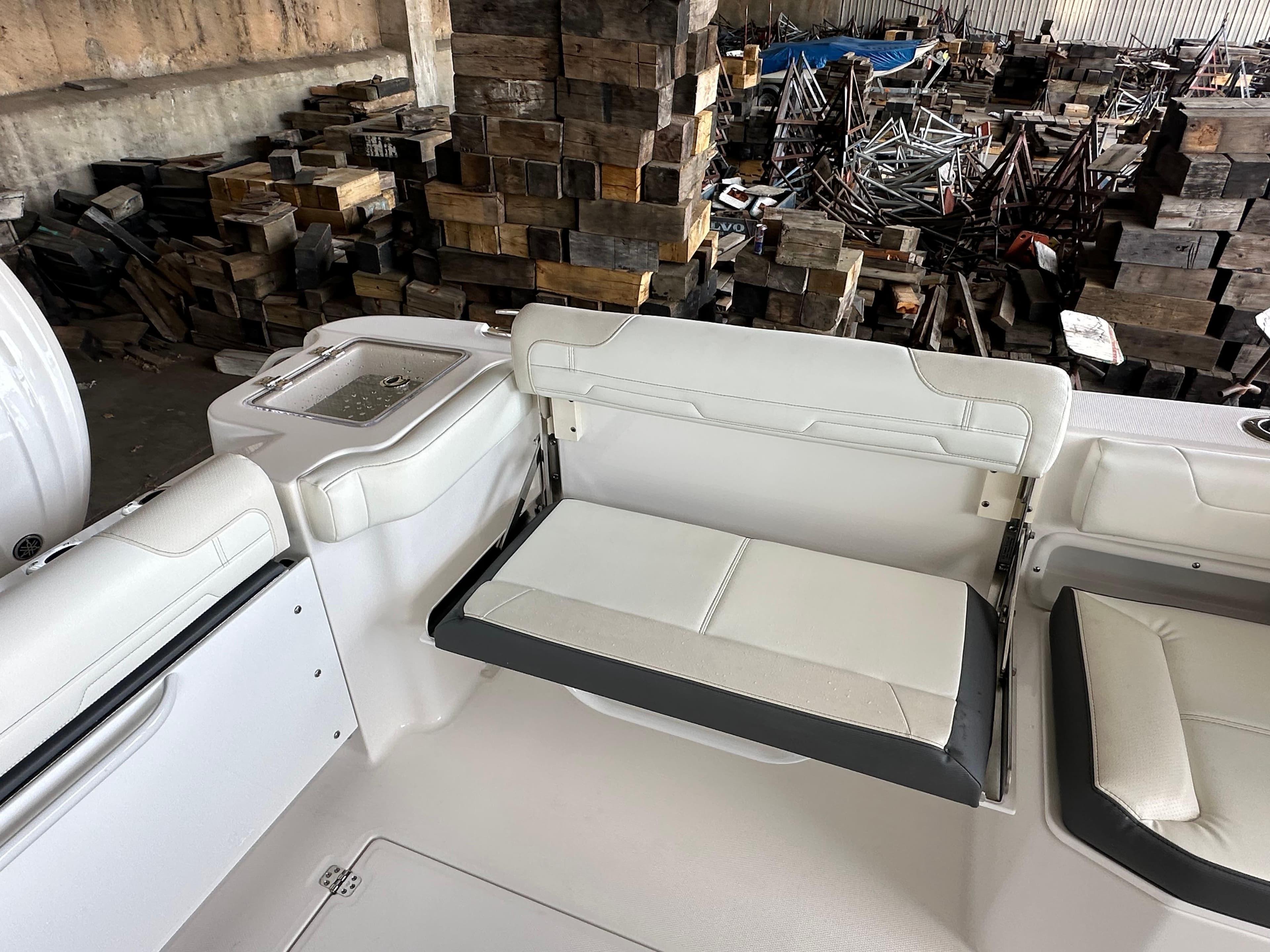 2026 Edgewater 262CX Crossover boat interior with white seating and storage area.