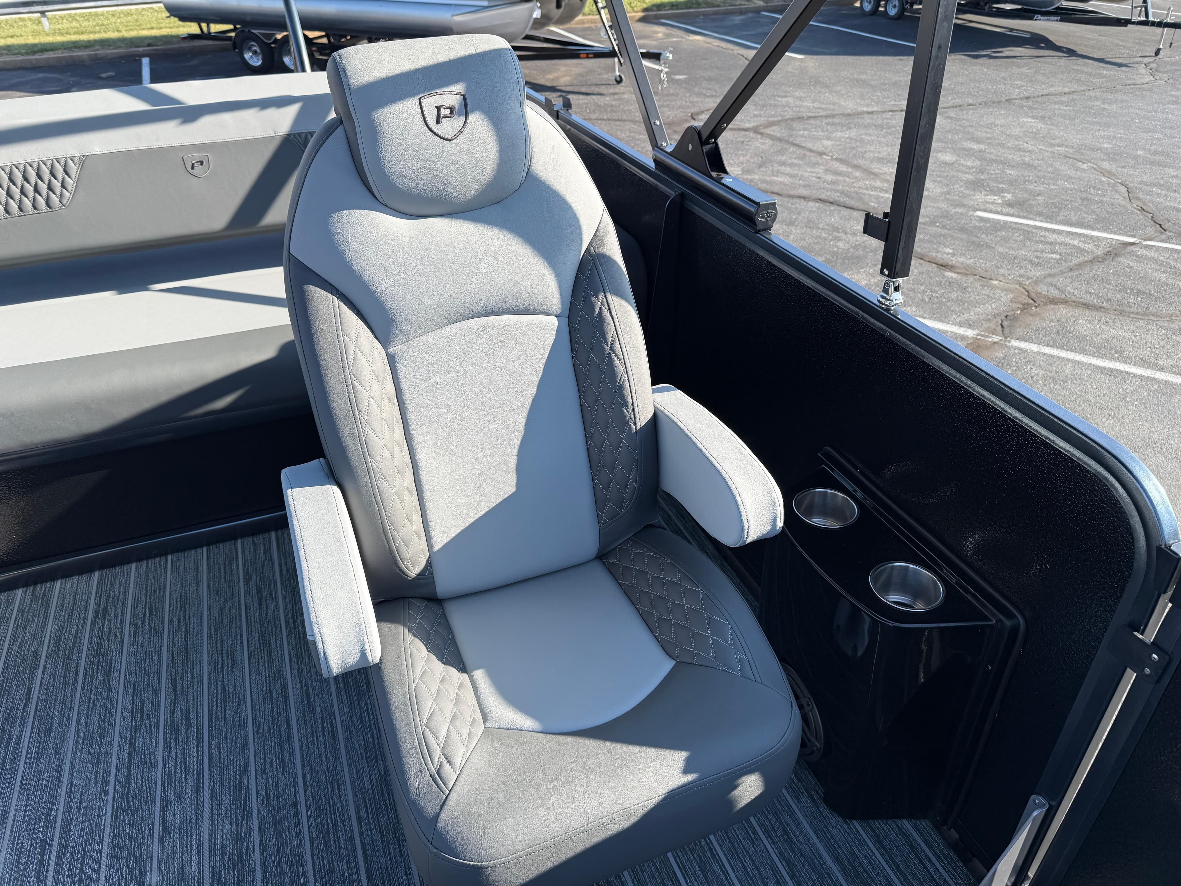 Luxurious seating in 2025 Premier 230 Solaris RL boat with cup holders and stylish design.