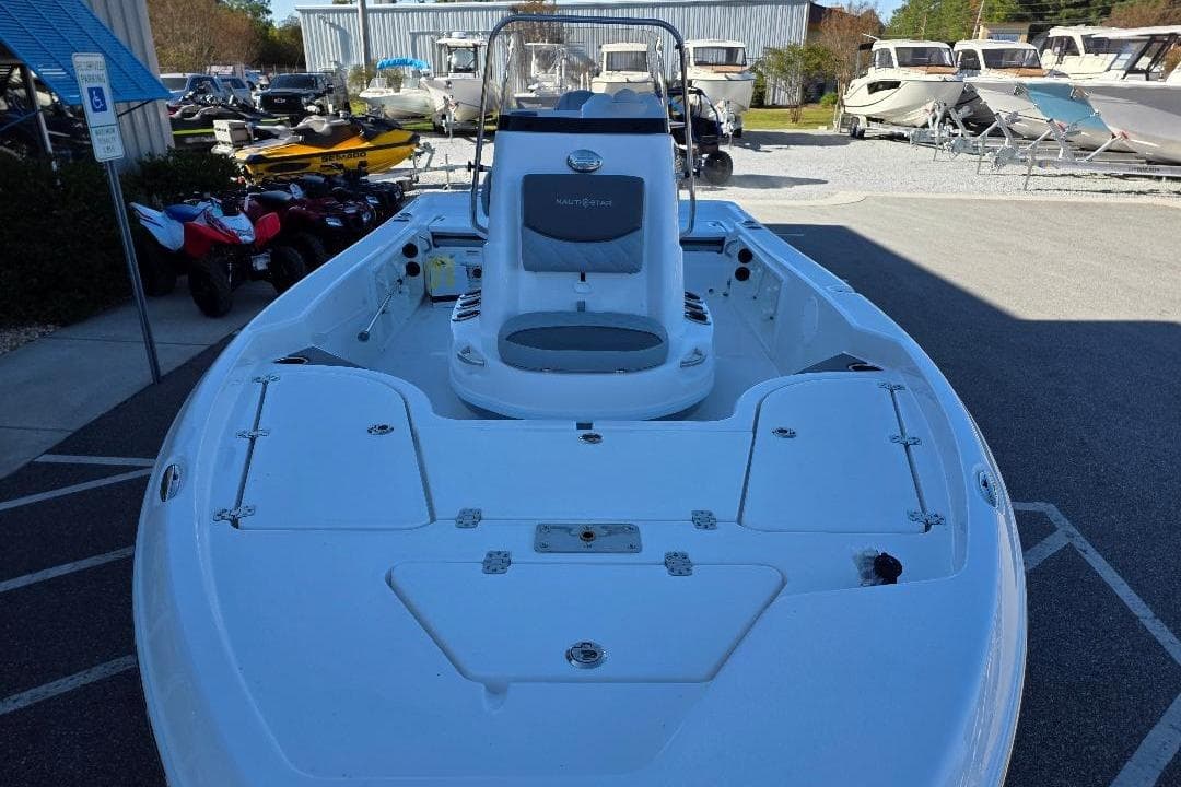2026 NauticStar 194 Bay boat displayed outdoors, surrounded by other vehicles.