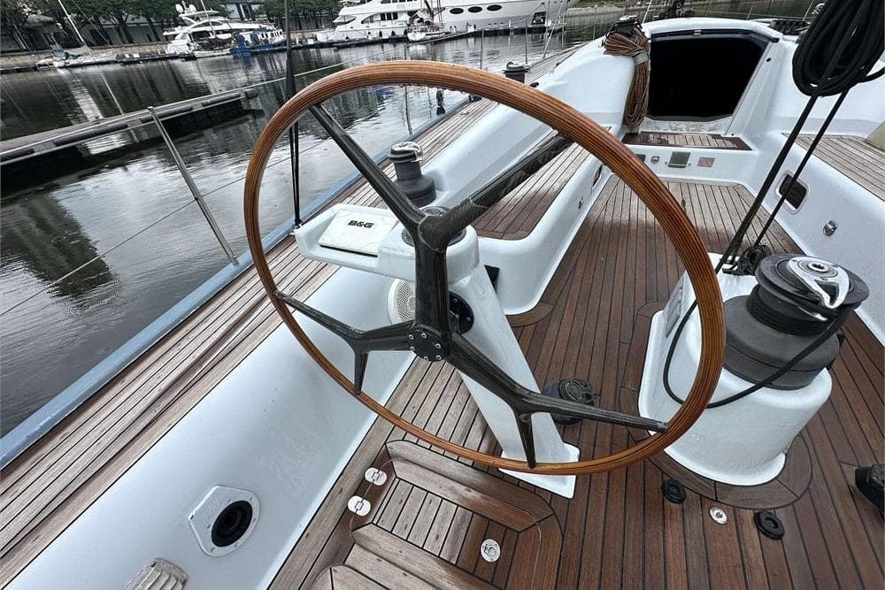 Steering wheel of a 2005 Simonis Voogd 56 yacht with wooden deck.