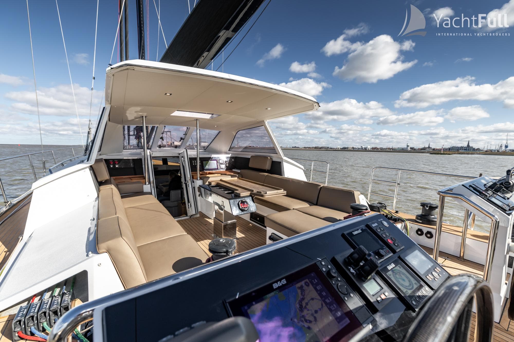 Luxurious 2022 Garcia Exploration 60 yacht interior with navigation equipment and comfortable seating.
