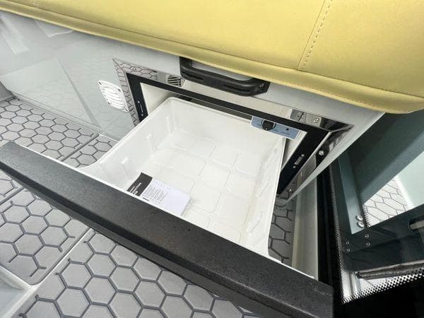 2024 XO Boats DFNDR 9 interior with open storage compartment and hexagonal floor design.