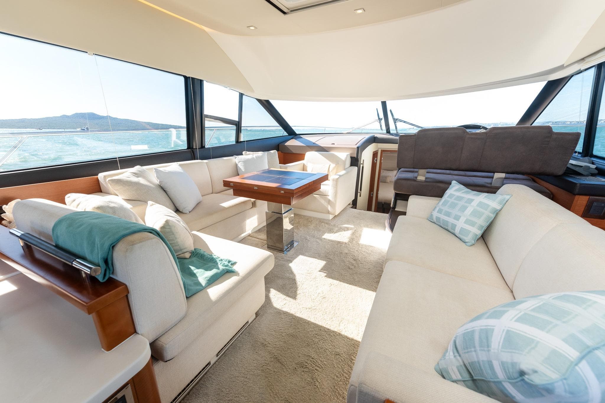 Luxurious interior of 2017 Prestige 500 yacht with plush seating and panoramic windows.