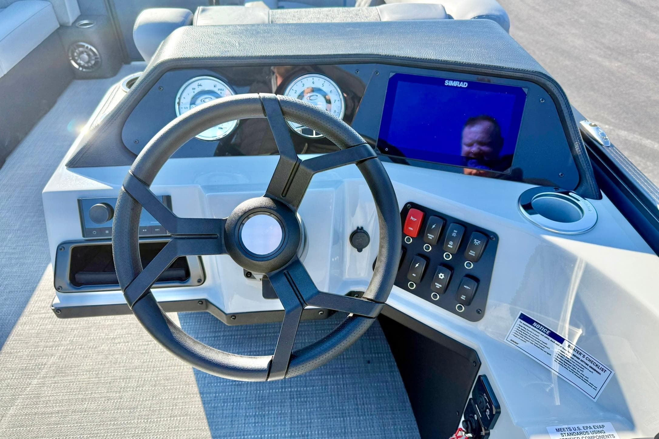 Steering console of 2026 Crest Conquest 210 Fish boat with modern controls and display.