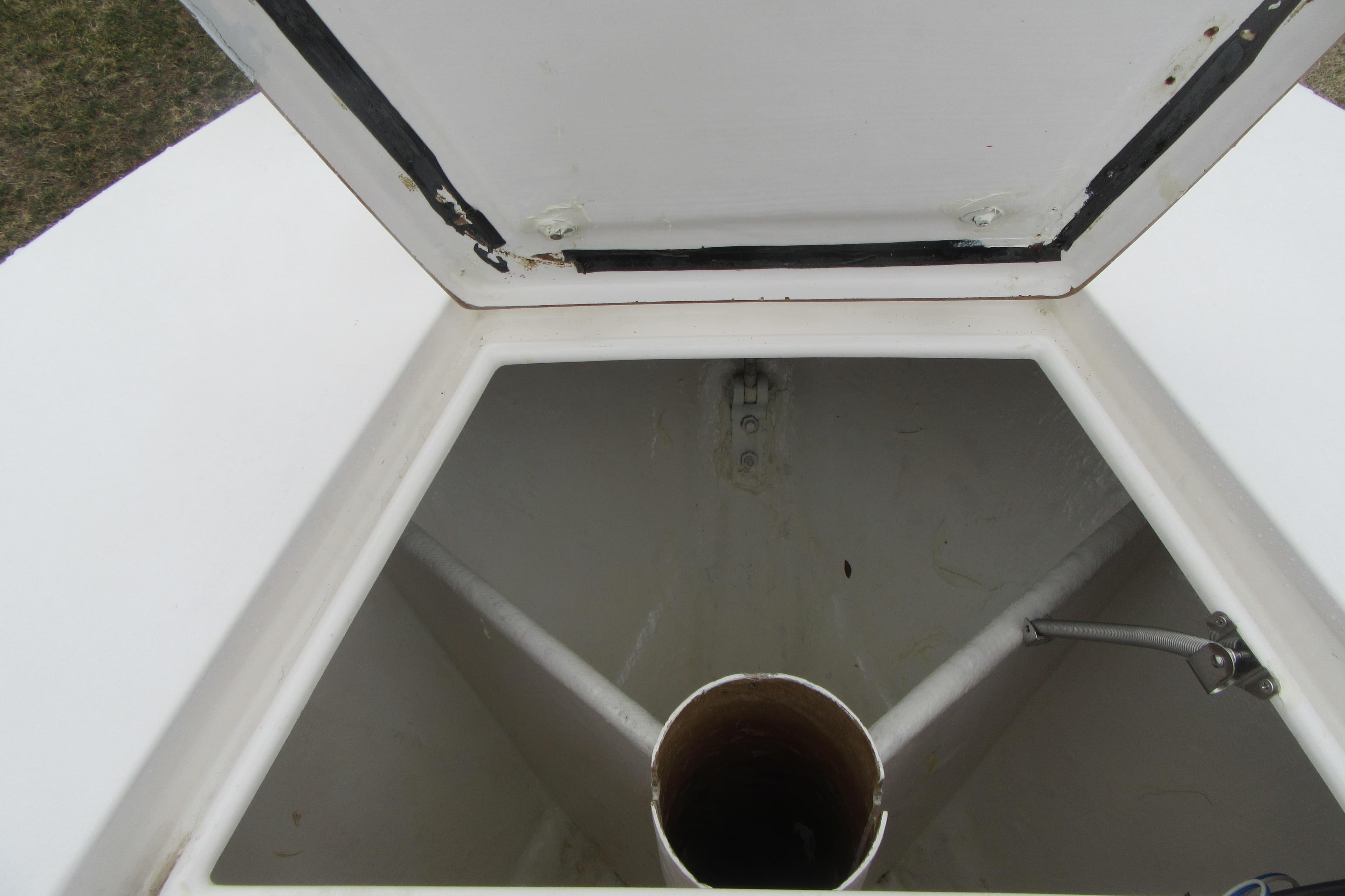 Open storage compartment on a 2005 Contender 23 CC boat.