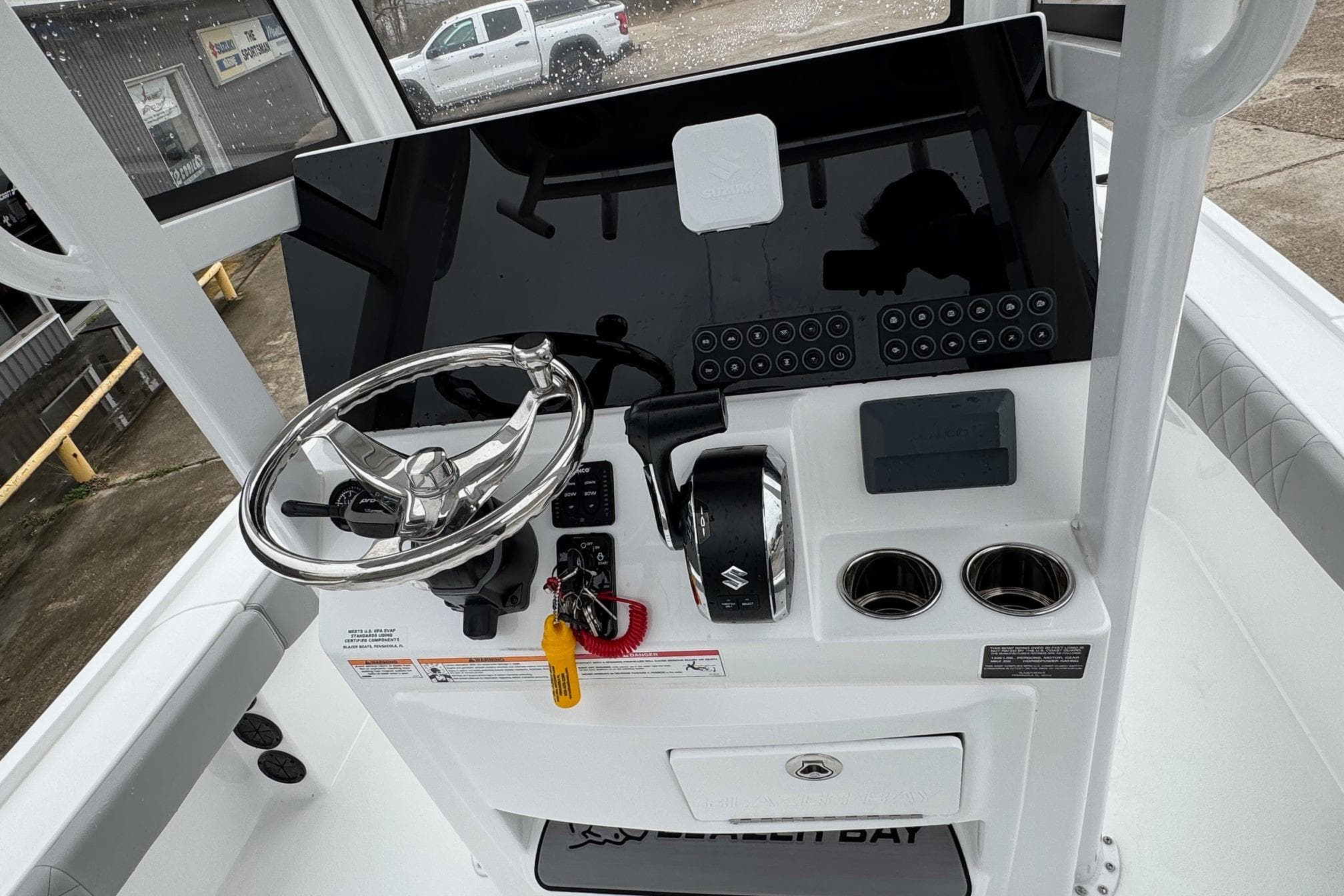 2026 Blazer Bay 2440 boat console with steering wheel and controls.